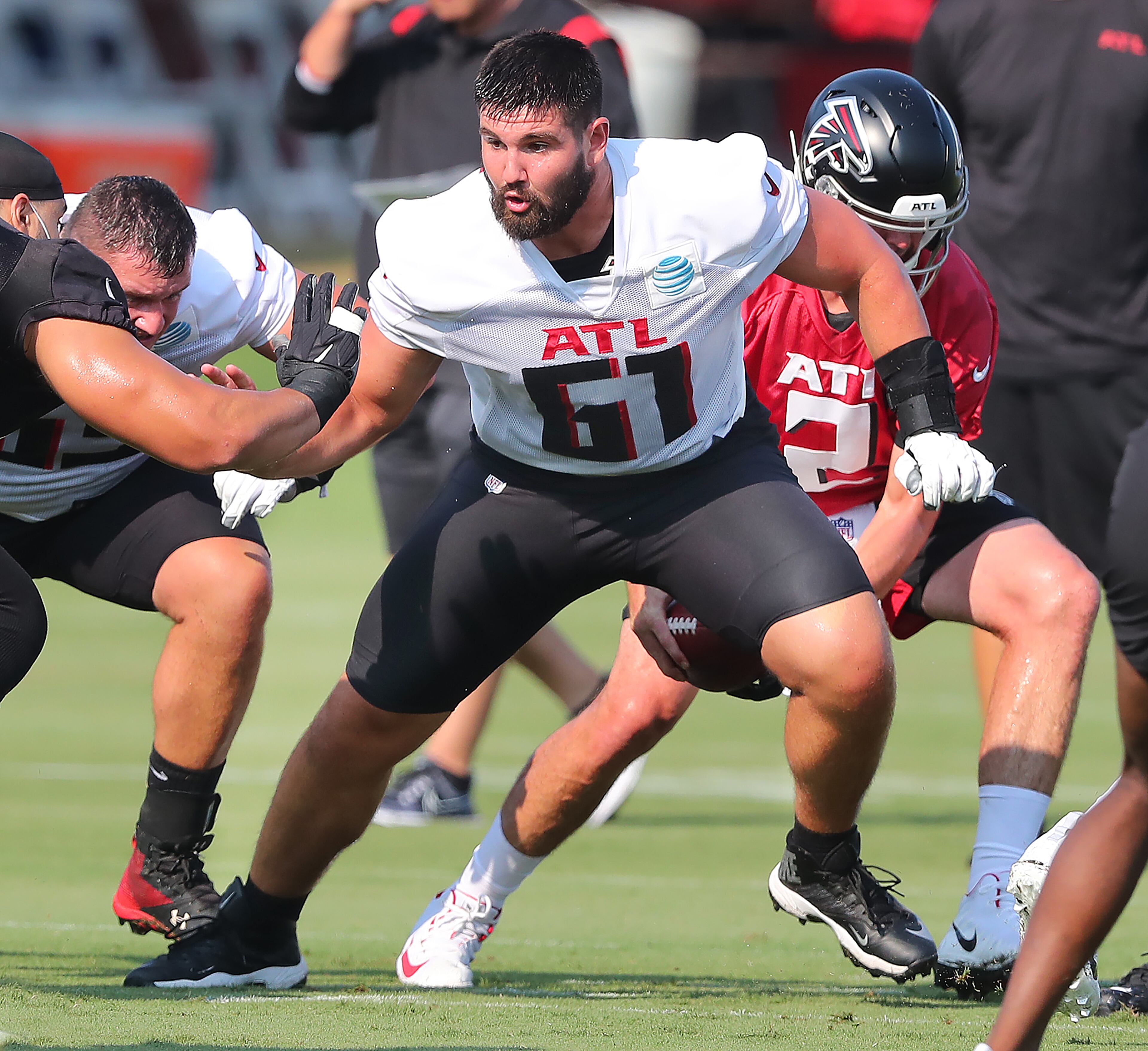 072921 Flowery Branch: Atlanta Falcons center Matt Hennessy blocks for Matt Ryan on a offensive play during the first day of training camp practice at the team training facility on Thursday, July 29, 2021, in Flowery Branch. “Curtis Compton / Curtis.Compton@ajc.com”