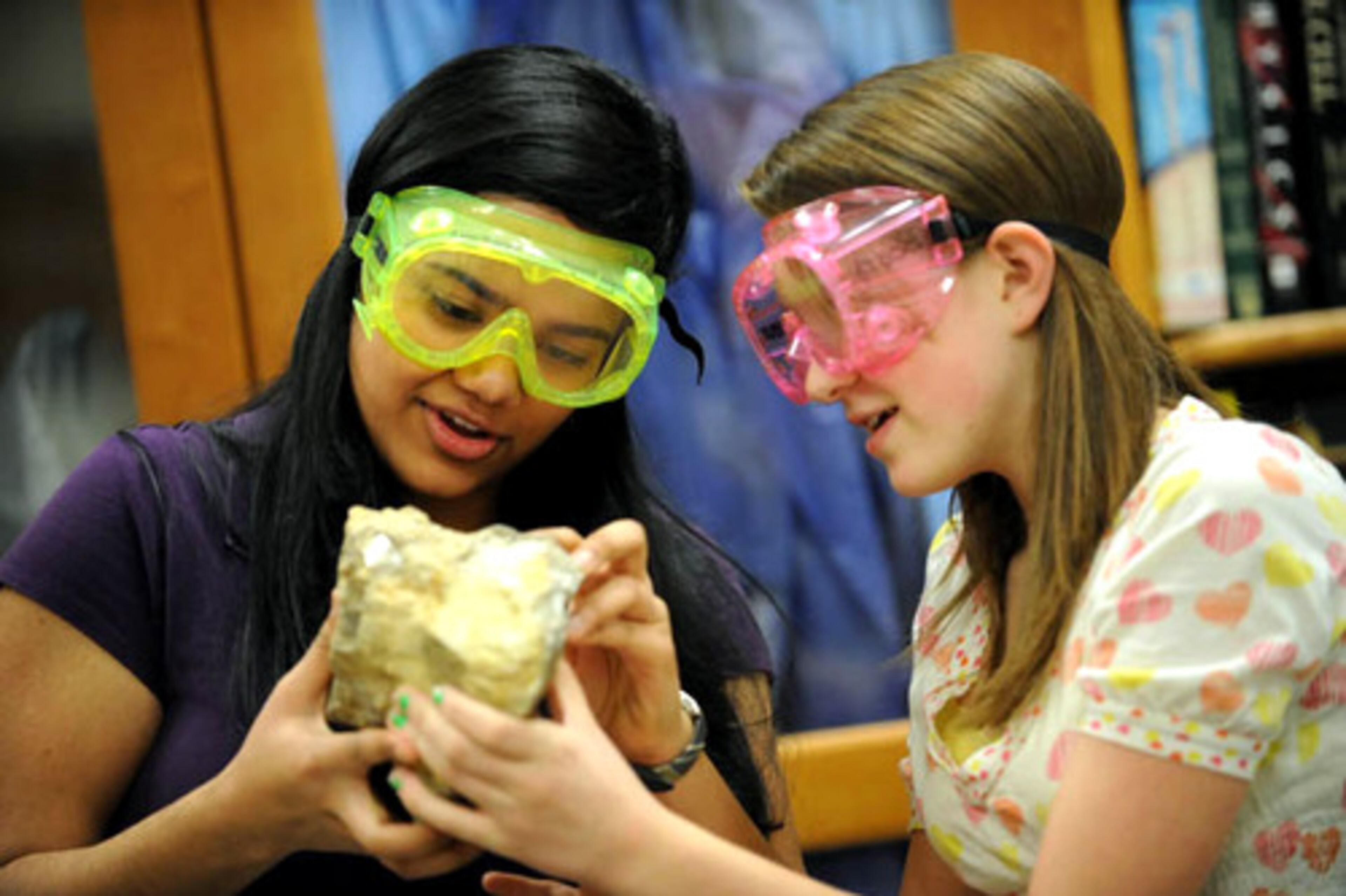 Ninth graders Brahma NaTarajan (left) and Hannah Chambless examine a rock at J.C. Booth Middle School. Rocks and Minerals is an event where students identify various samples and answer questions about their structures, uses and physical characteristics.