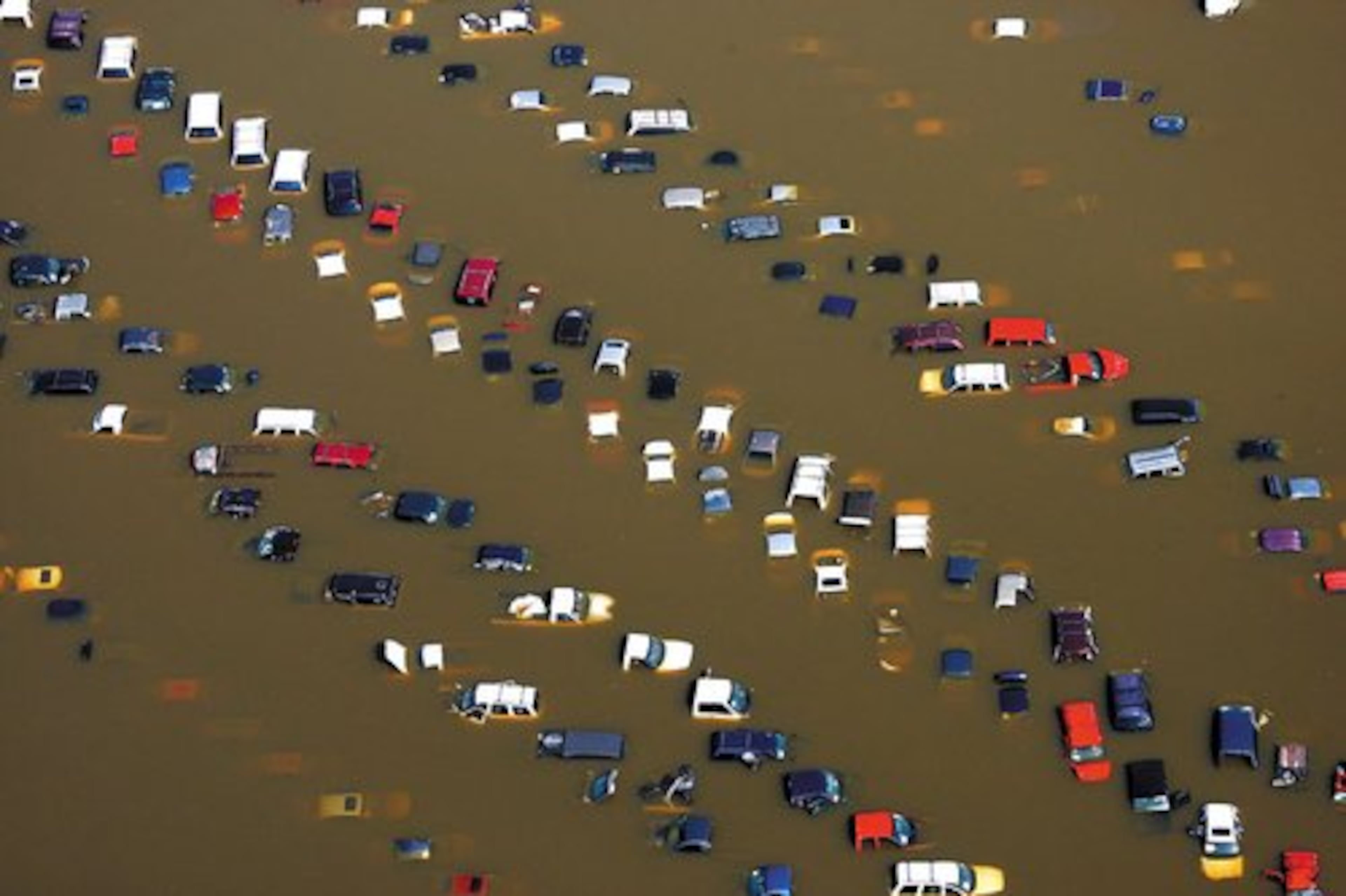 Cars stand submerged in overflow water from the Wolf River on McMiller Road in Memphis, Tenn.