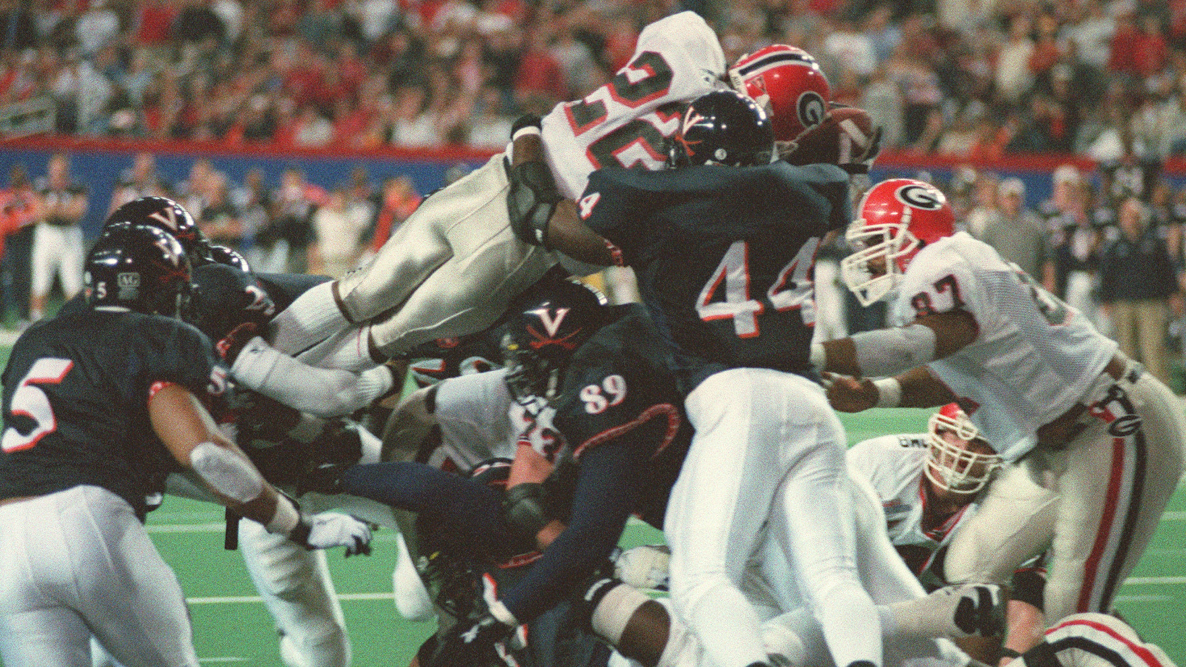 981231 ATLANTA: University of Georgia's Olandis Gary (22,cq) flies over the top for a 4th quarter UGA touchdown to put UGA ahead of Virginia for good during their Peach Bowl matchup at the Georgia Dome on New Year's Eve 12/31/98. (DAVID TULIS/Staff)