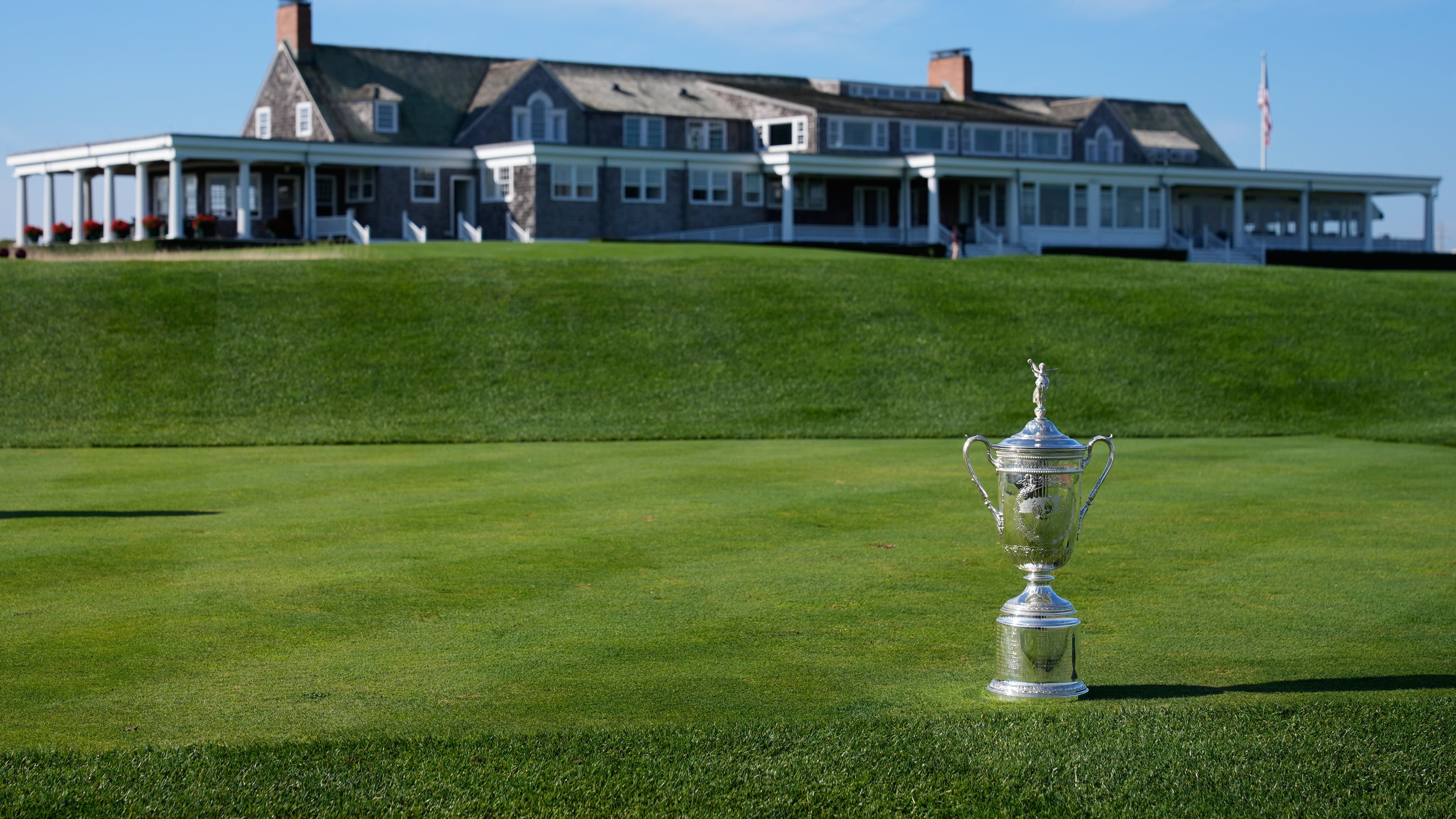 FILE - The U.S. Open Golf Championship trophy is displayed in front of the clubhouse at Shinnecock Hills Golf Club in Southampton, N.Y., Sept. 15, 2025. (AP Photo/Seth Wenig, File)