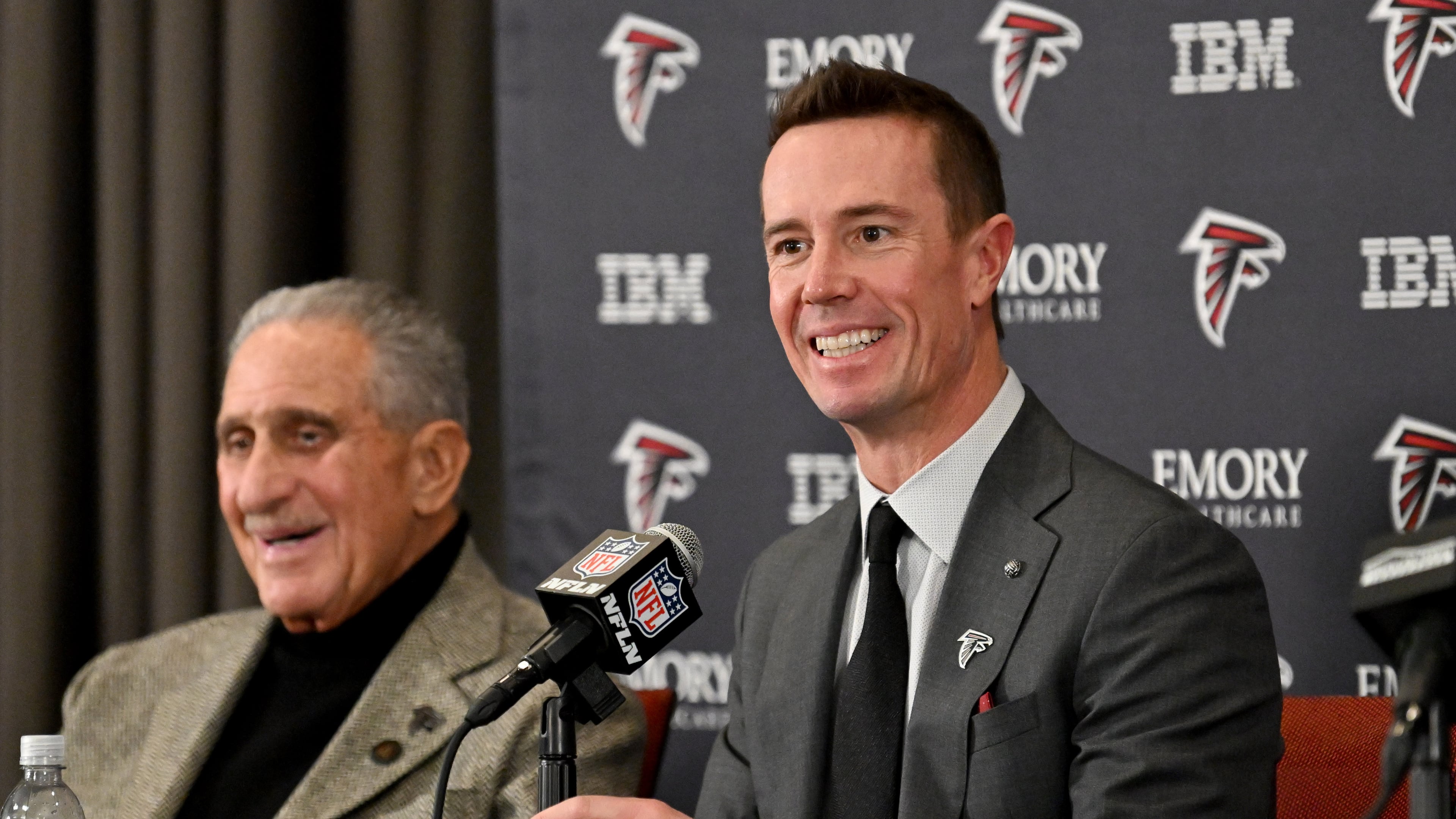New Atlanta Falcons president of football Matt Ryan speaks as Falcons owner Arthur M. Blank (left) reacts during an introductory news conference Jan. 13, 2026, in Flowery Branch. It is now thought Ryan could be leaning toward James Liipfert as the team's new general manager. (Hyosub Shin/AJC)