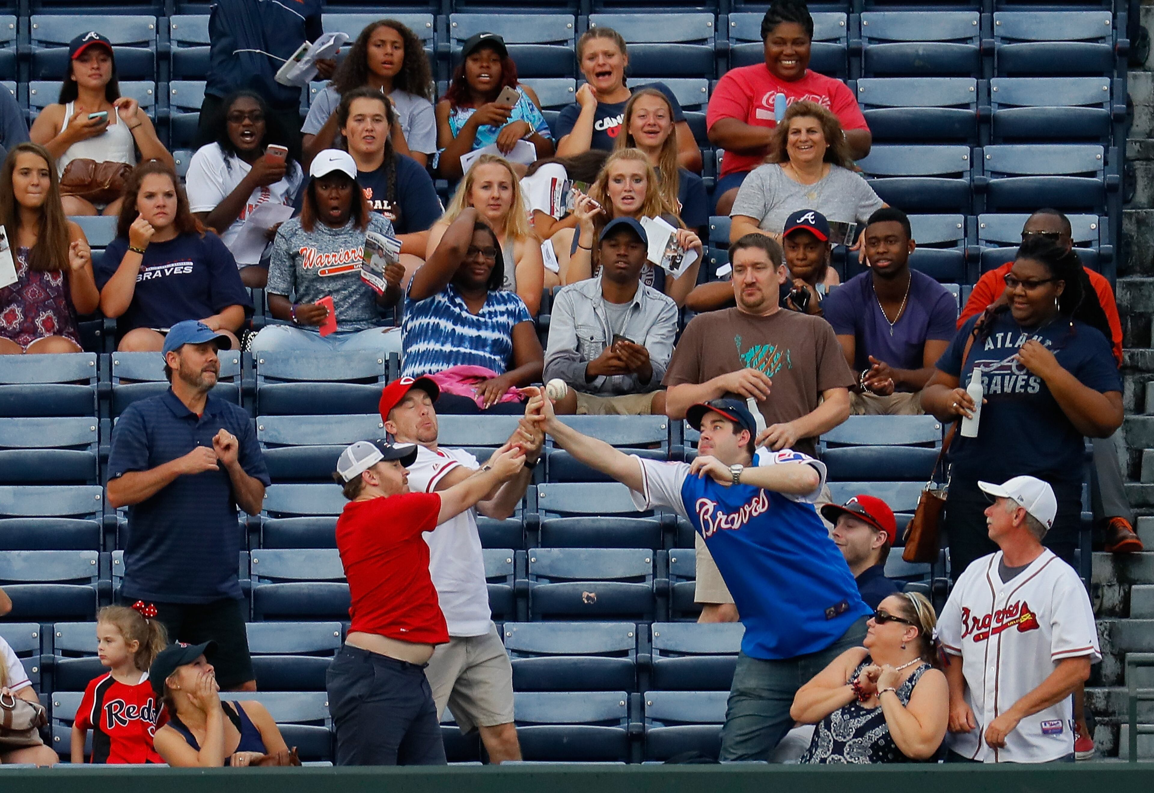 ATLANTA, GA - JUNE 14: Fans attempt to catch a three-run homer hit by Jay Bruce #32 of the Cincinnati Reds in the first inning against the Atlanta Braves at Turner Field on June 14, 2016 in Atlanta, Georgia. (Photo by Kevin C. Cox/Getty Images)