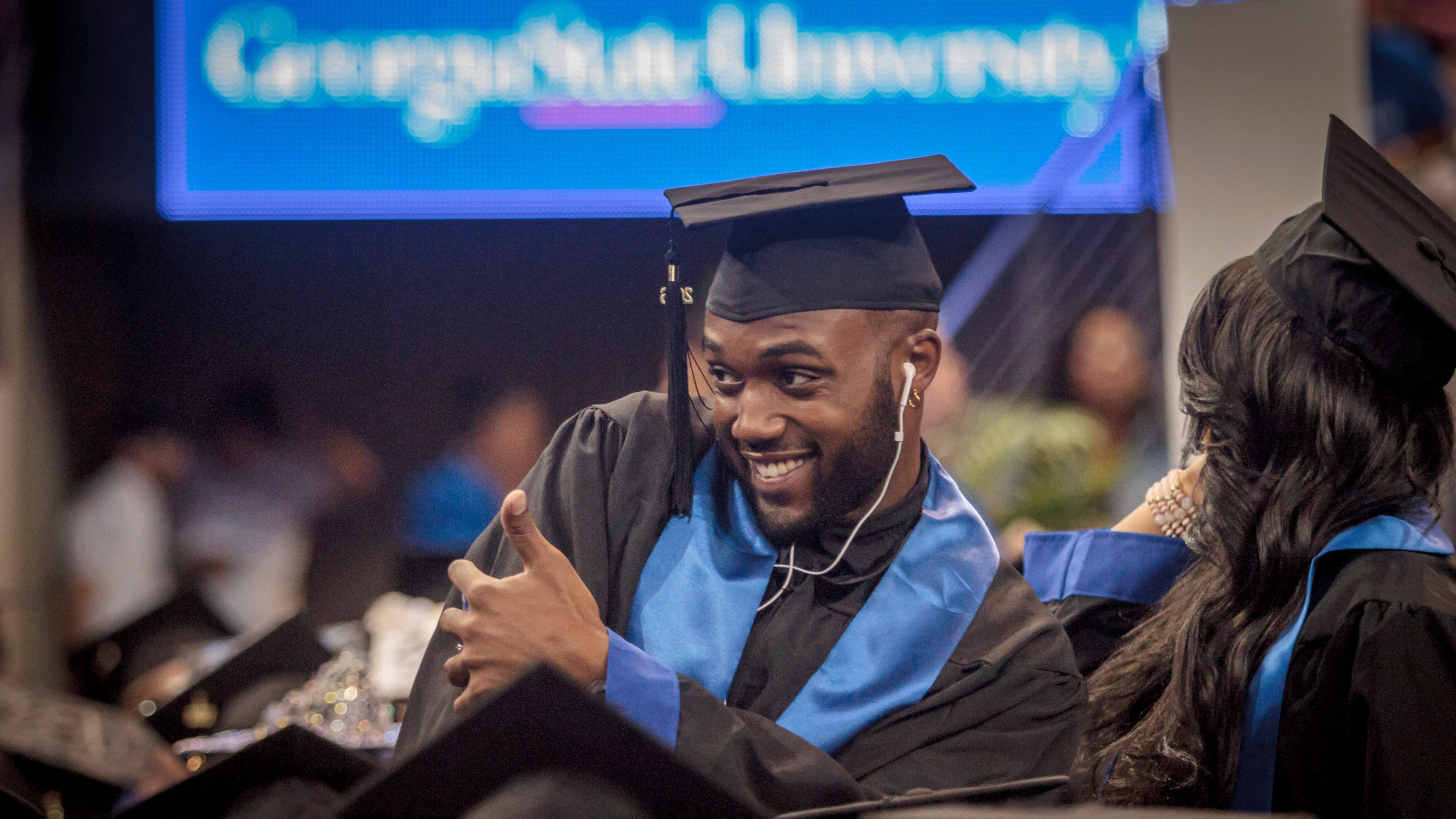 A Georgia State University student poses for a photograph before the start of his graduation ceremony in Atlanta last year. How do we get more Georgians to this point?