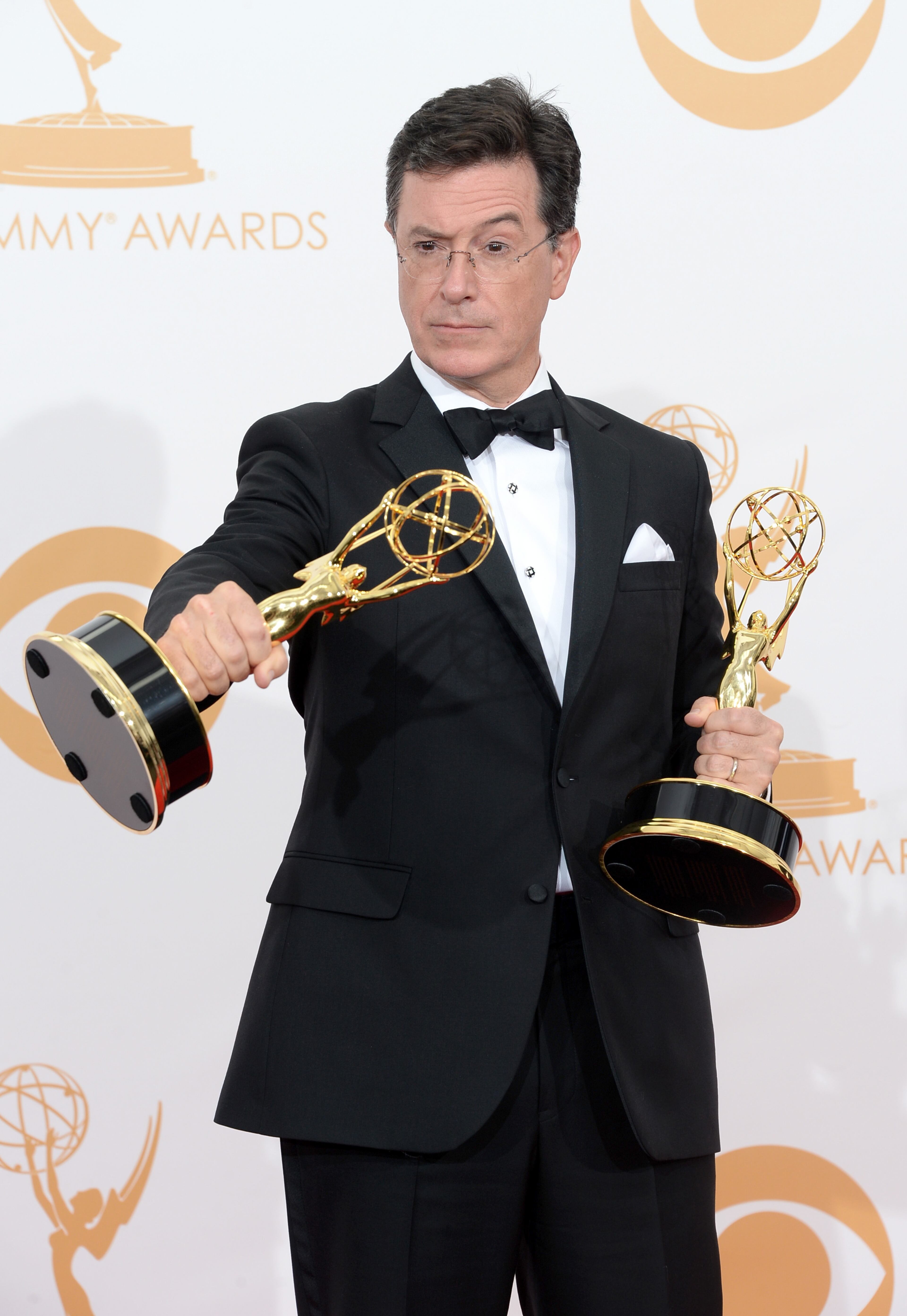 LOS ANGELES, CA - SEPTEMBER 22: TV personaity Stephen Colbert, winner of the Best Writing for a Variety Series Award and the Variety Series Award for "The Colbert Report" poses in the press room during the 65th Annual Primetime Emmy Awards held at Nokia Theatre L.A. Live on September 22, 2013 in Los Angeles, California. (Photo by Jason Merritt/Getty Images)