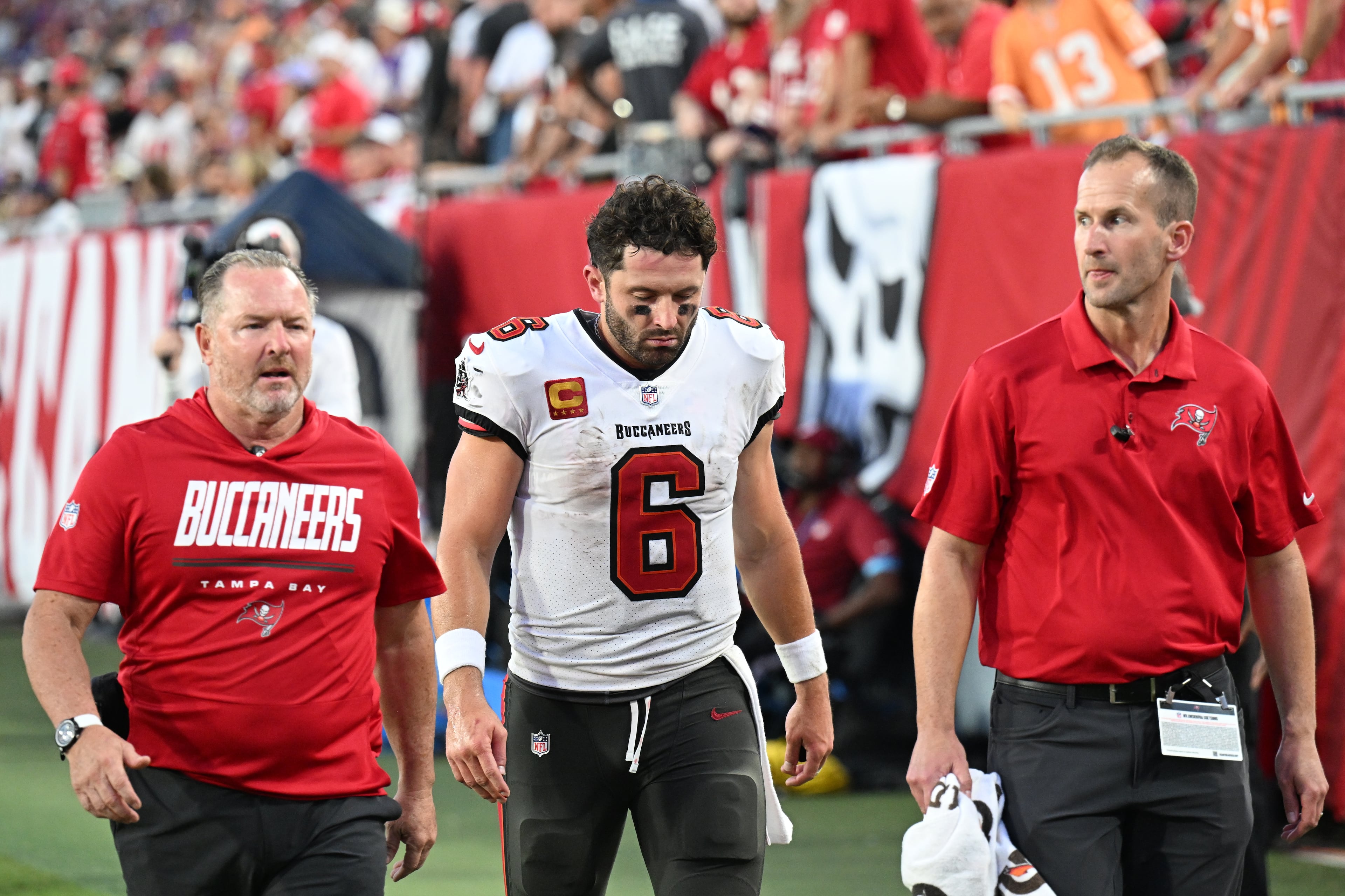 Buccaneers quarterback Baker Mayfield (center) leaves the field during their game against the Vikings on Sunday, Sept. 27, 2026, in Tampa, Fla. Mayfield is expected to miss a minimum of three weeks because of a dislocated thumb. (Jason Behnken/AP)