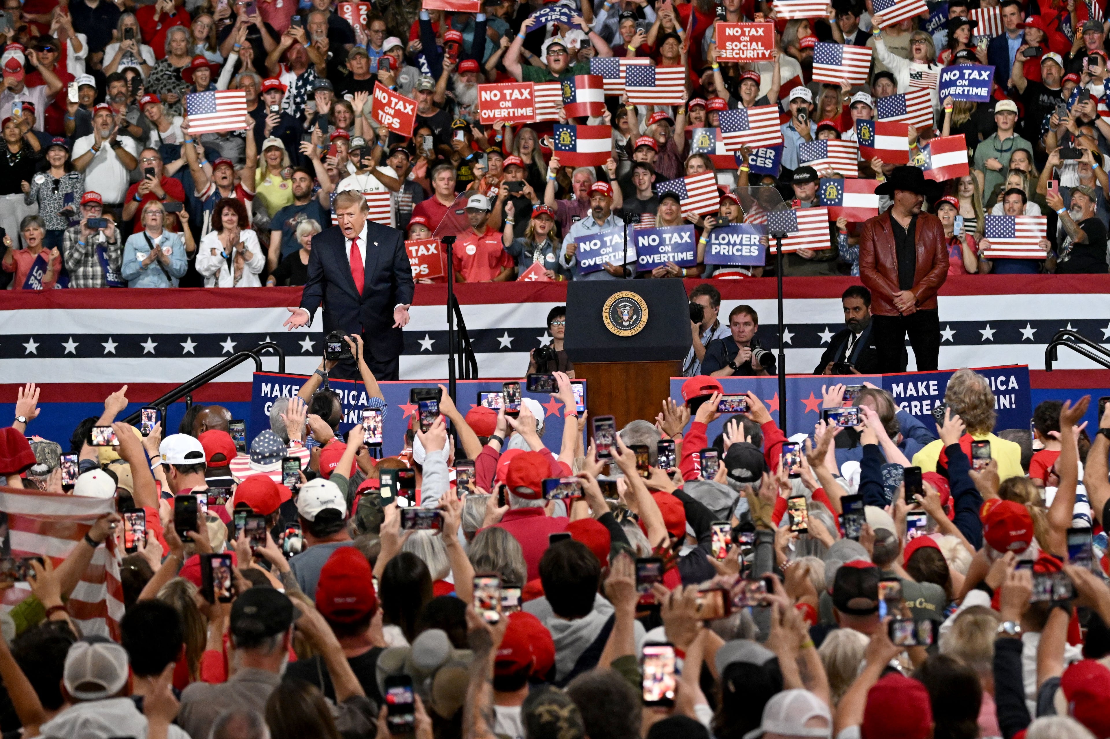 President Donald Trump waves as he takes the stage during a midterm campaign rally at Guardian Centers on Saturday, Oct. 24, 2026, in Perry. (Hyosub Shin/AJC)