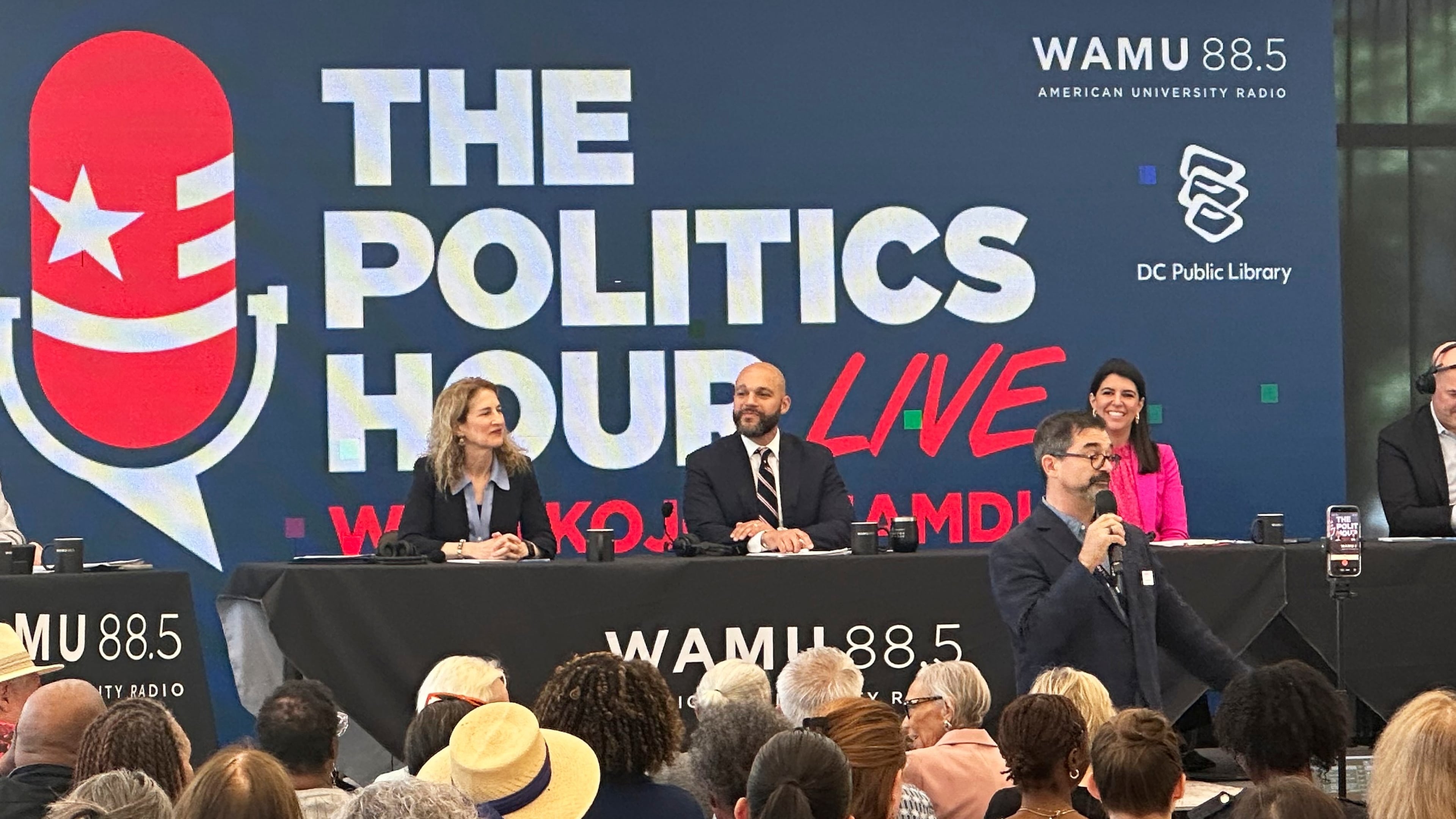 Robert White Jr., center, and Brooke Pinto, right, candidates for Washington D.C. delegate, participate in a forum at the Martin Luther King Jr. Memorial Library, Friday, May 29, 2026. (AP Photo/Gary Fields)