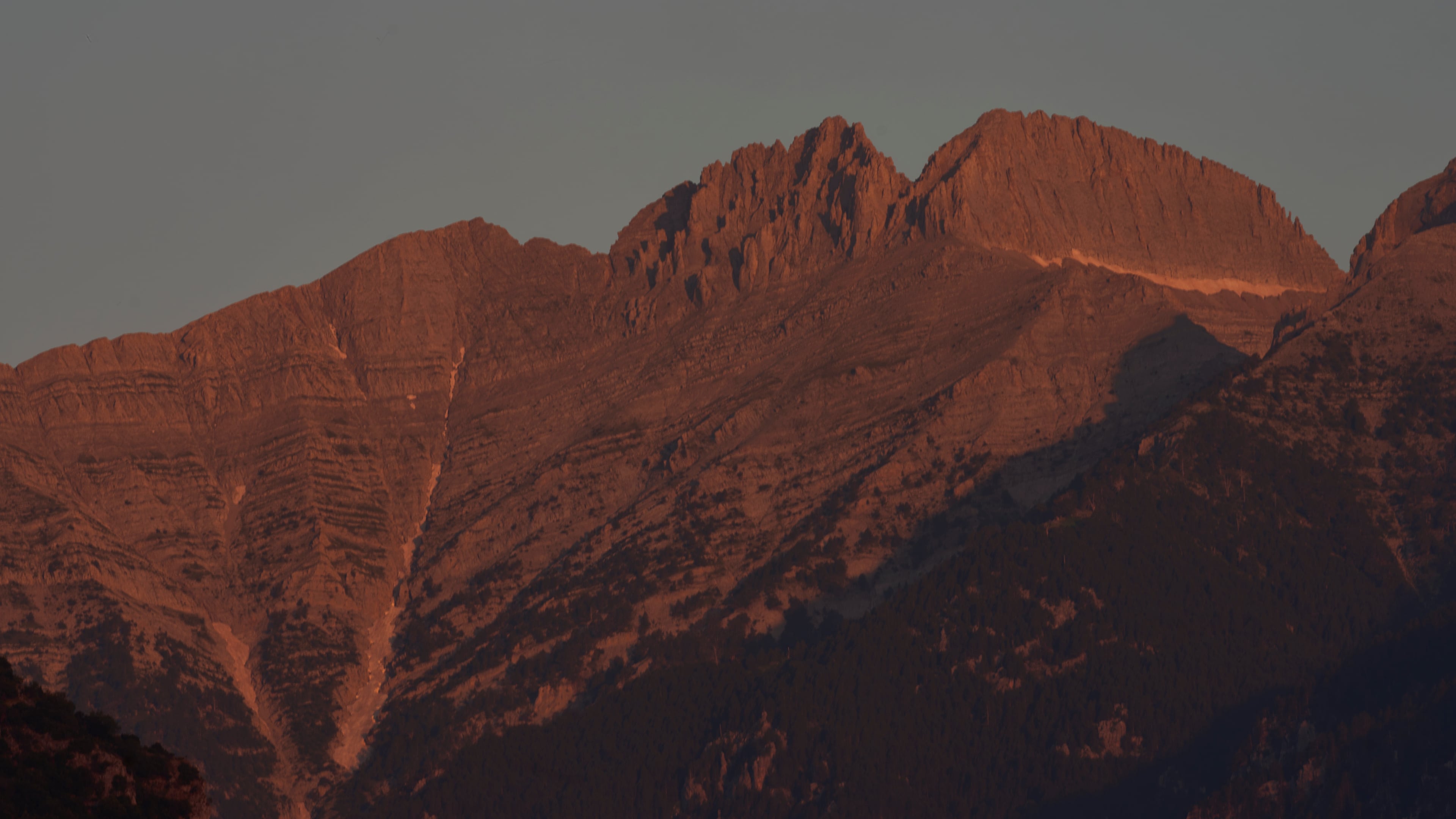 The morning light shines on Mytikas, Greece's highest peak, center left, and Stefani, known as the Throne of Zeus, center right, atop Mount Olympus seen from the outskirts of Litochoro in northern Greece, Wednesday, July 15, 2026. (AP Photo/Petros Giannakouris)