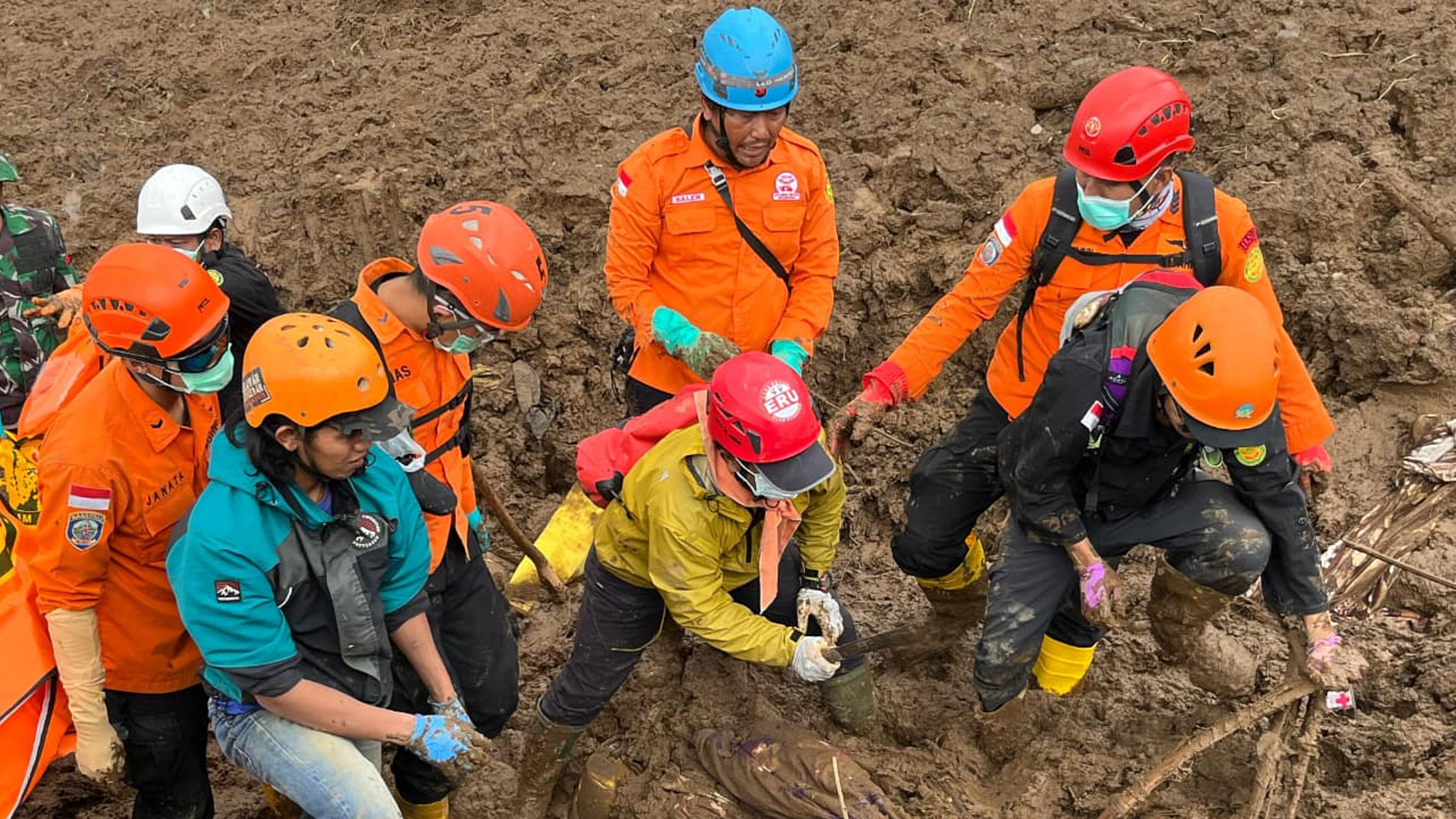 In this photo released by the Indonesian National Search and Rescue Agency (BASARNAS), rescuers search for victims in Pasir Langu village after a landslide, in West Bandung district of West Java province, Indonesia, Sunday, Jan. 25, 2026. (BASARNAS via AP)