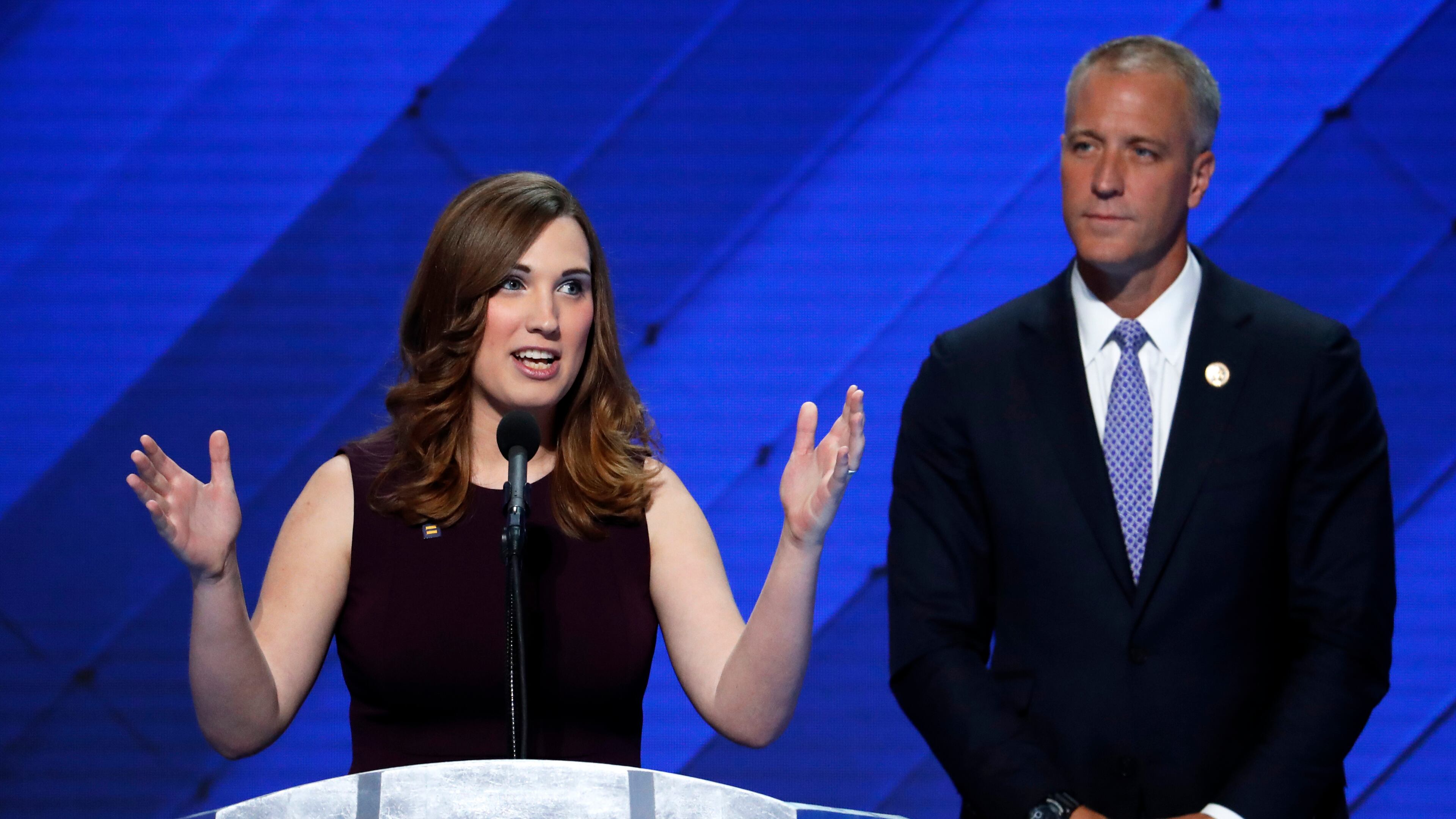 LGBT rights activist Sarah McBride speaks as Rep. Sean Patrick Maloney, D-NY, Co-Chair of the Congressional LGBT Equality Caucus listens during the final day of the Democratic National Convention in Philadelphia , Thursday, July 28, 2016. (AP Photo/J. Scott Applewhite)