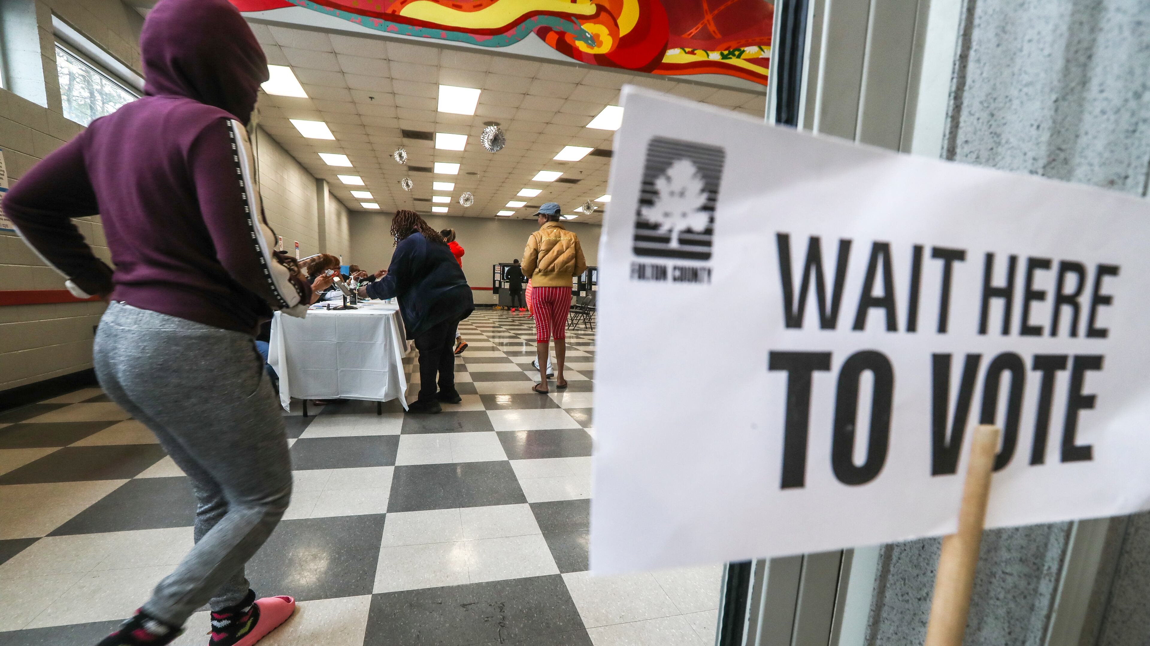 Voters enter on Tuesday, Dec. 6, 2022 at the C.T. Martin Natatorium and Recreation Center located at 3201 M.L.K. Jr Drive SW in Atlanta. (John Spink / John.Spink@ajc.com)