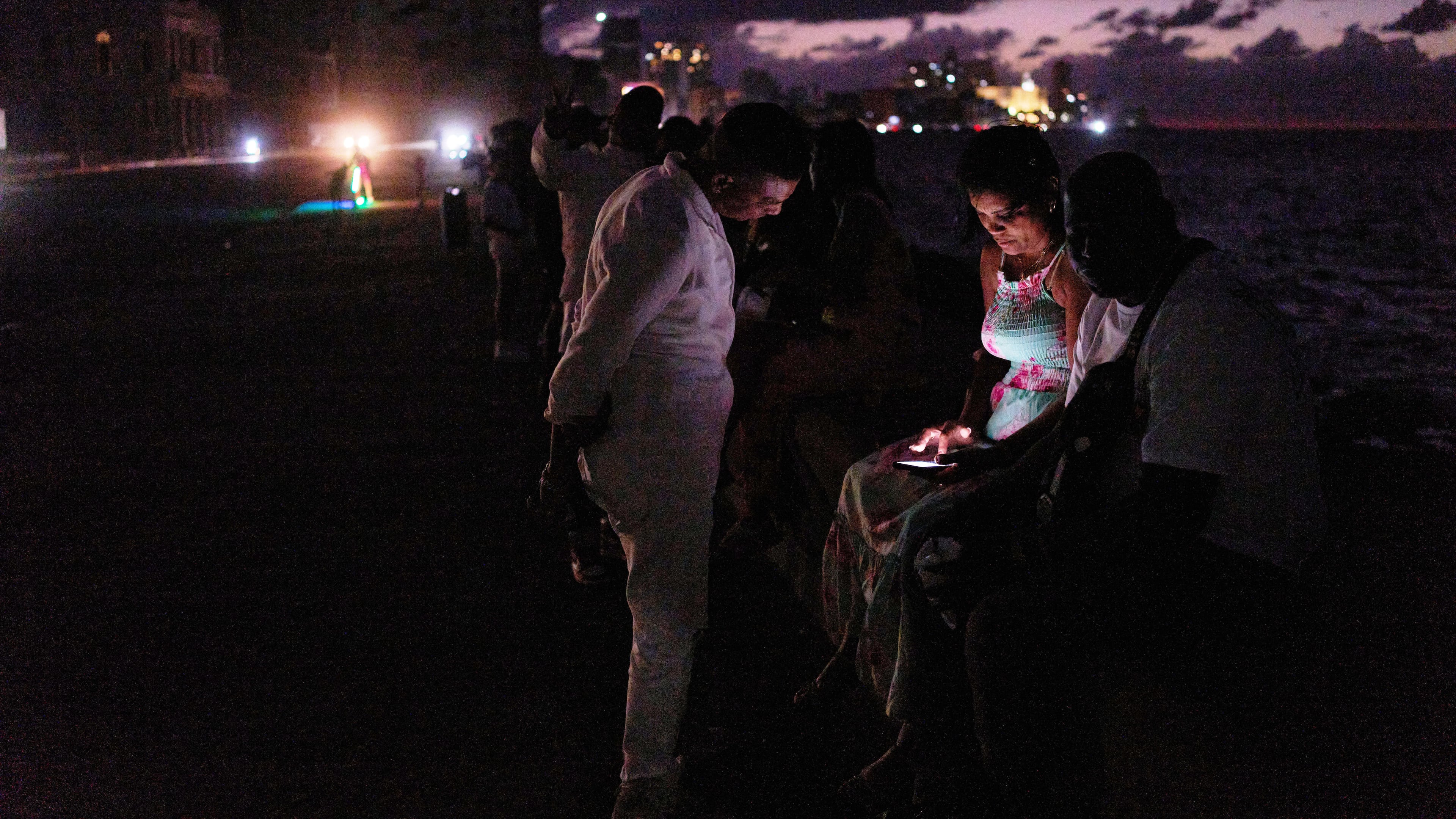 People spend the night in the dark on the Malecon during a blackout in Havana, Cuba, Saturday, March 21, 2026. (AP Photo/Ramon Espinosa)