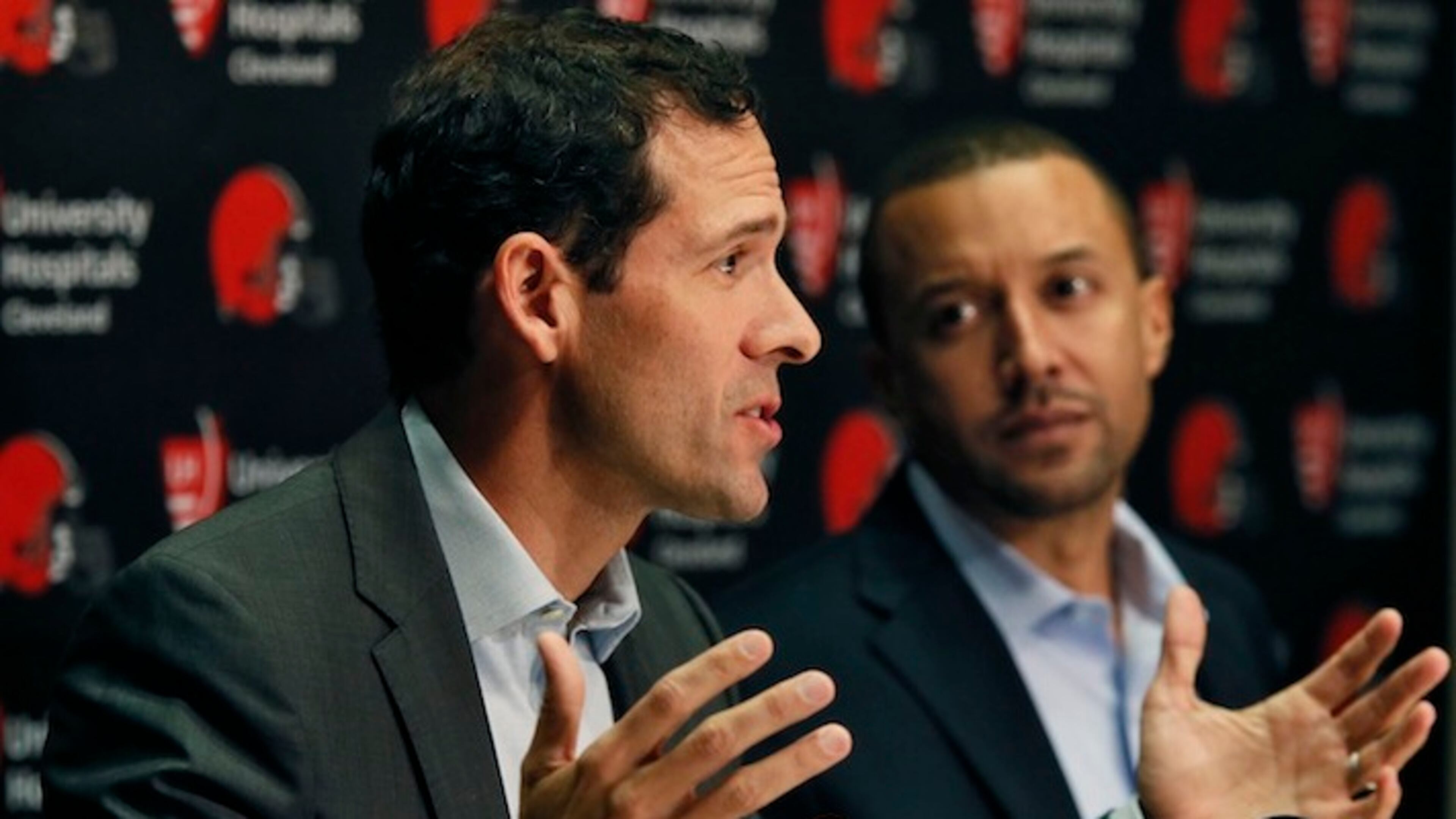 Cleveland Browns Chief Strategy Officer Paul DePodesta, left, answers a question while Executive Vice President of Football Operations Sashi Brown listens during a news conference at the Browns training facility on Thursday, Jan. 21, 2016, in Berea, Ohio. (Ed Suba Jr./Akron Beacon Journal/TNS)