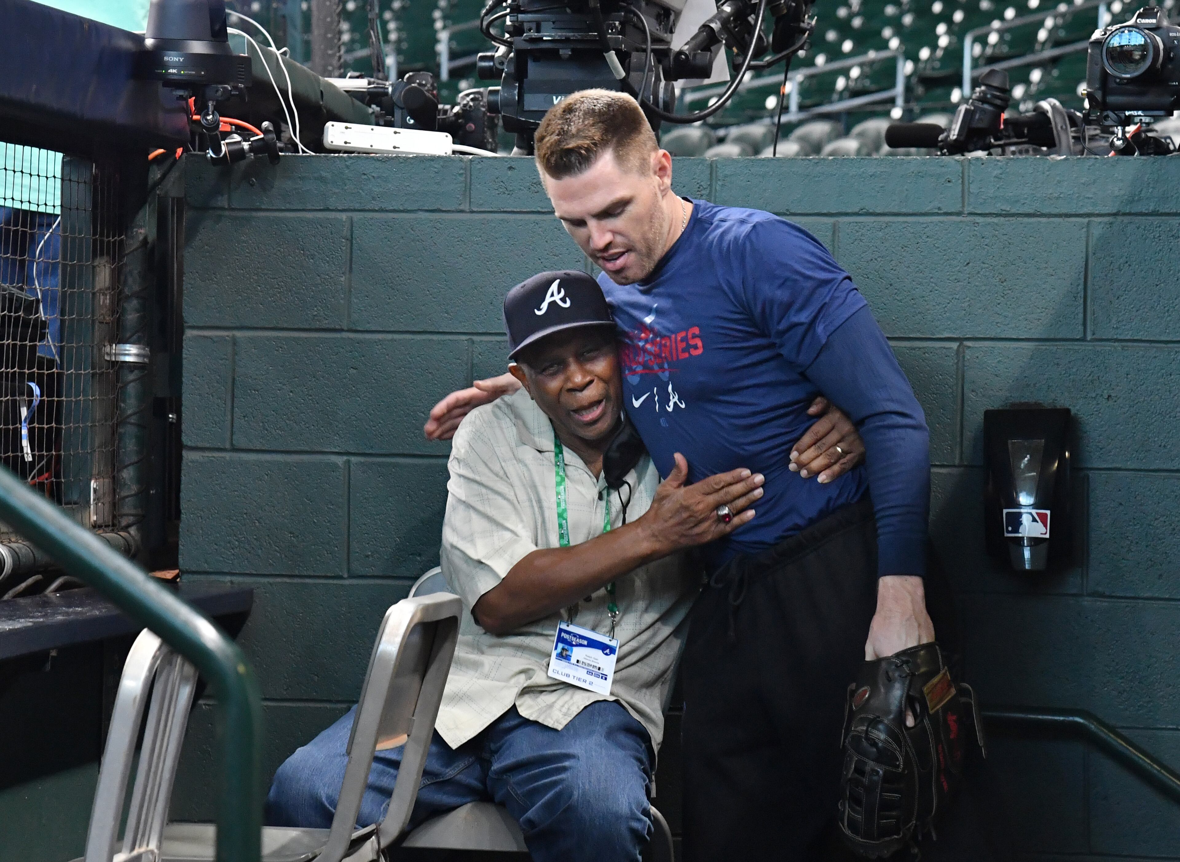 First baseman Freddie Freeman is greeted by former Atlanta Braves player Ralph Garr as he takes the field prior to Game 2 of baseball's World Series at Minute Maid Park in Houston on Wednesday, October 27, 2021. (Hyosub Shin / Hyosub.Shin@ajc.com)