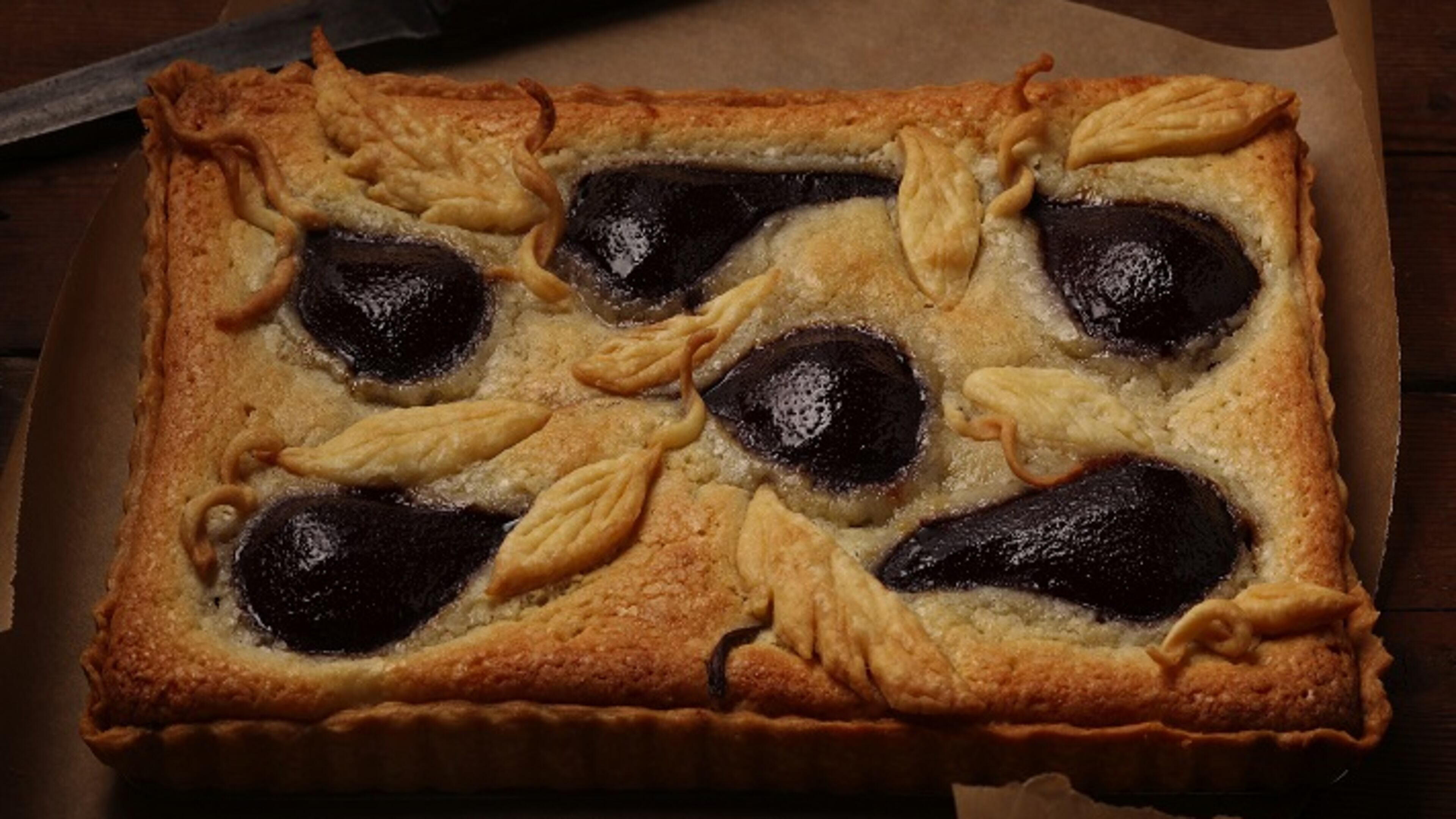 Fresh pears are poached in wine that has been flavored with vanilla and lemon, then added to a tart with almond filling. Joan Moravek / food styling (E. Jason Wambsgans/Chicago Tribune/TNS)