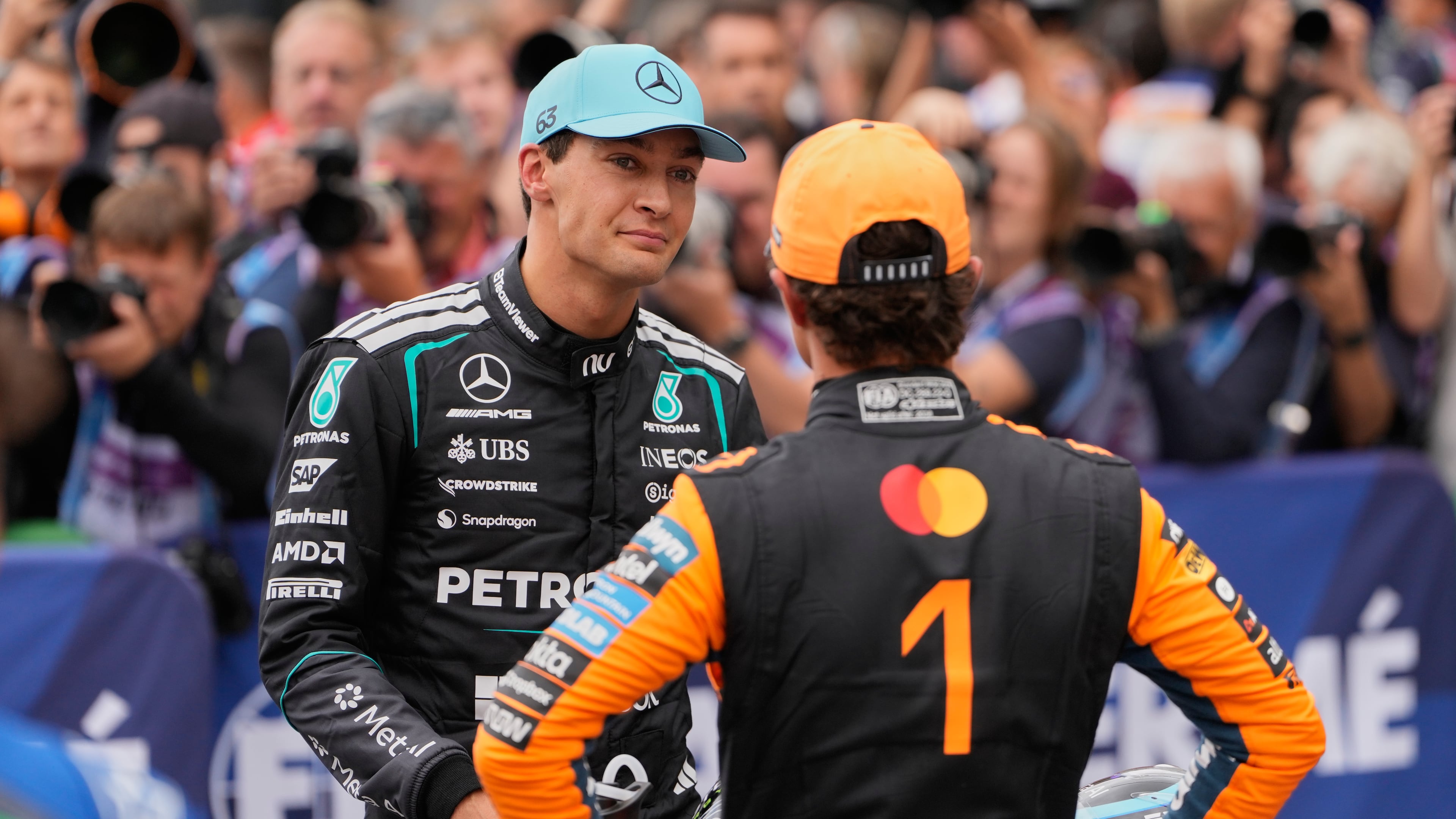 Mercedes driver George Russell of Britain, left, atlks to McLaren driver Lando Norris of Britain after the qualifying for the Formula One Dutch Grand Prix in Zandvoort , Netherlands, Saturday, Aug. 22, 2026. (AP Photo/Darko Bandic)