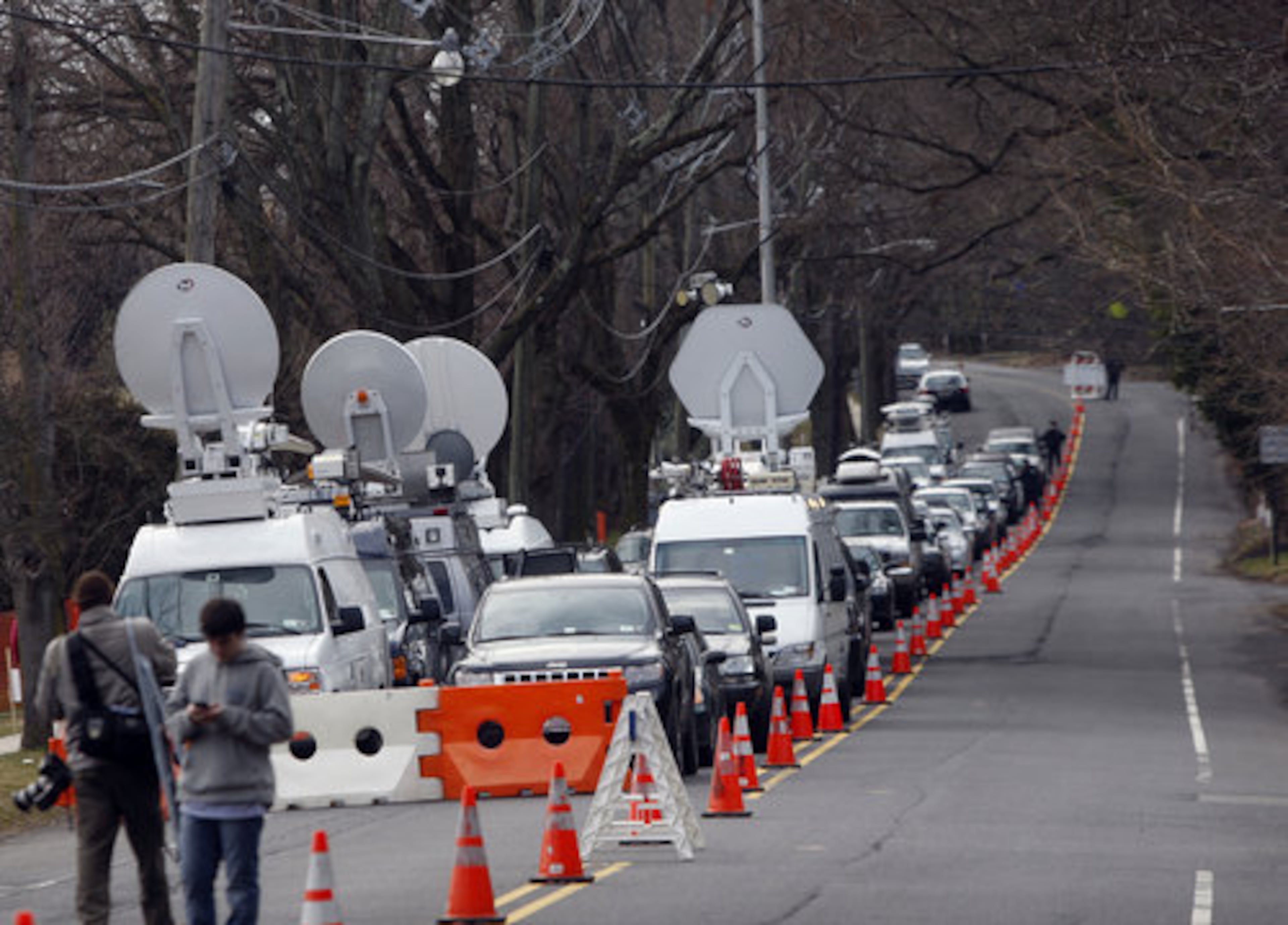 A long line of media vehicles line up to cover the burial of Whitney Houston at Fairview Cemetery for her burial in Westfield, N.J., Sunday, Feb. 19, 2012.