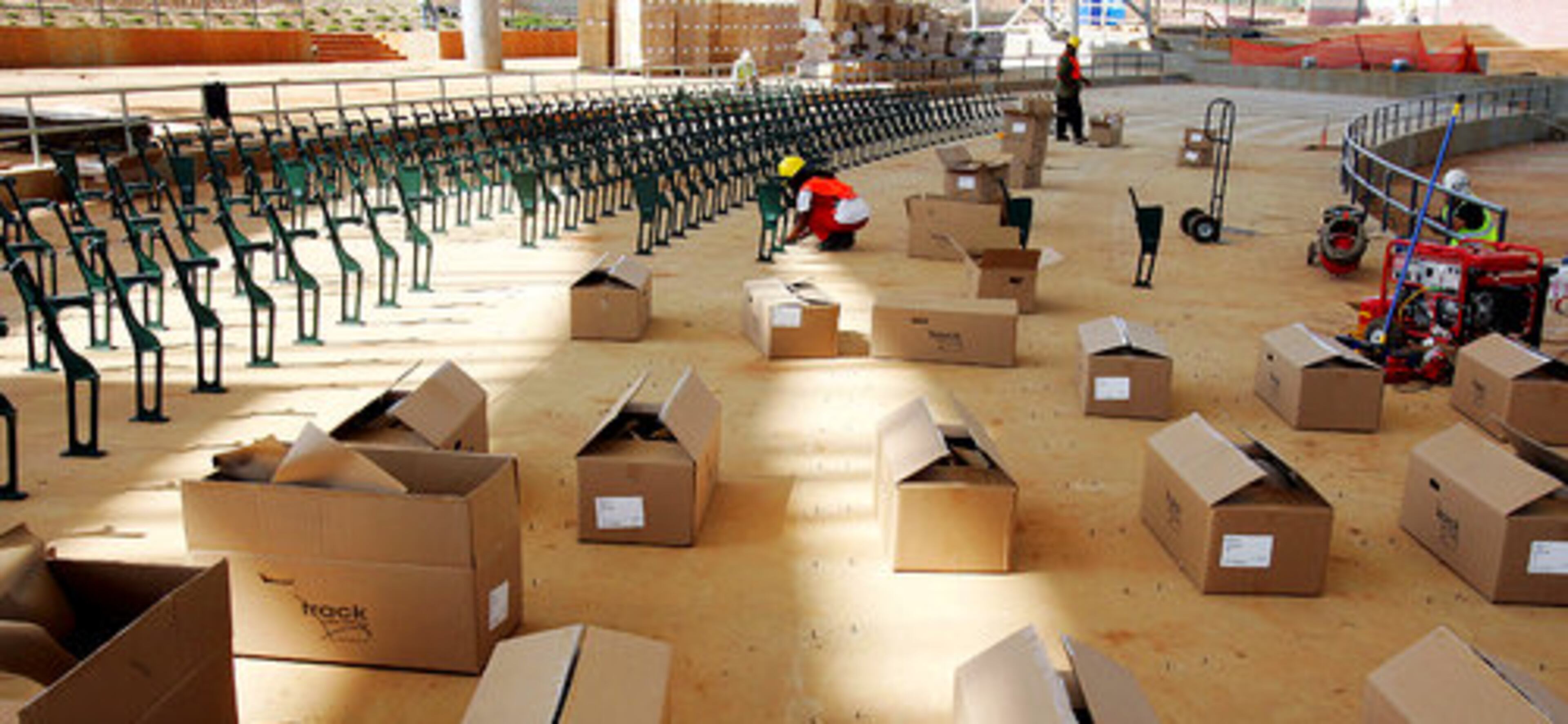 Seats are taken out of the boxes and then installed on back of the seating area.