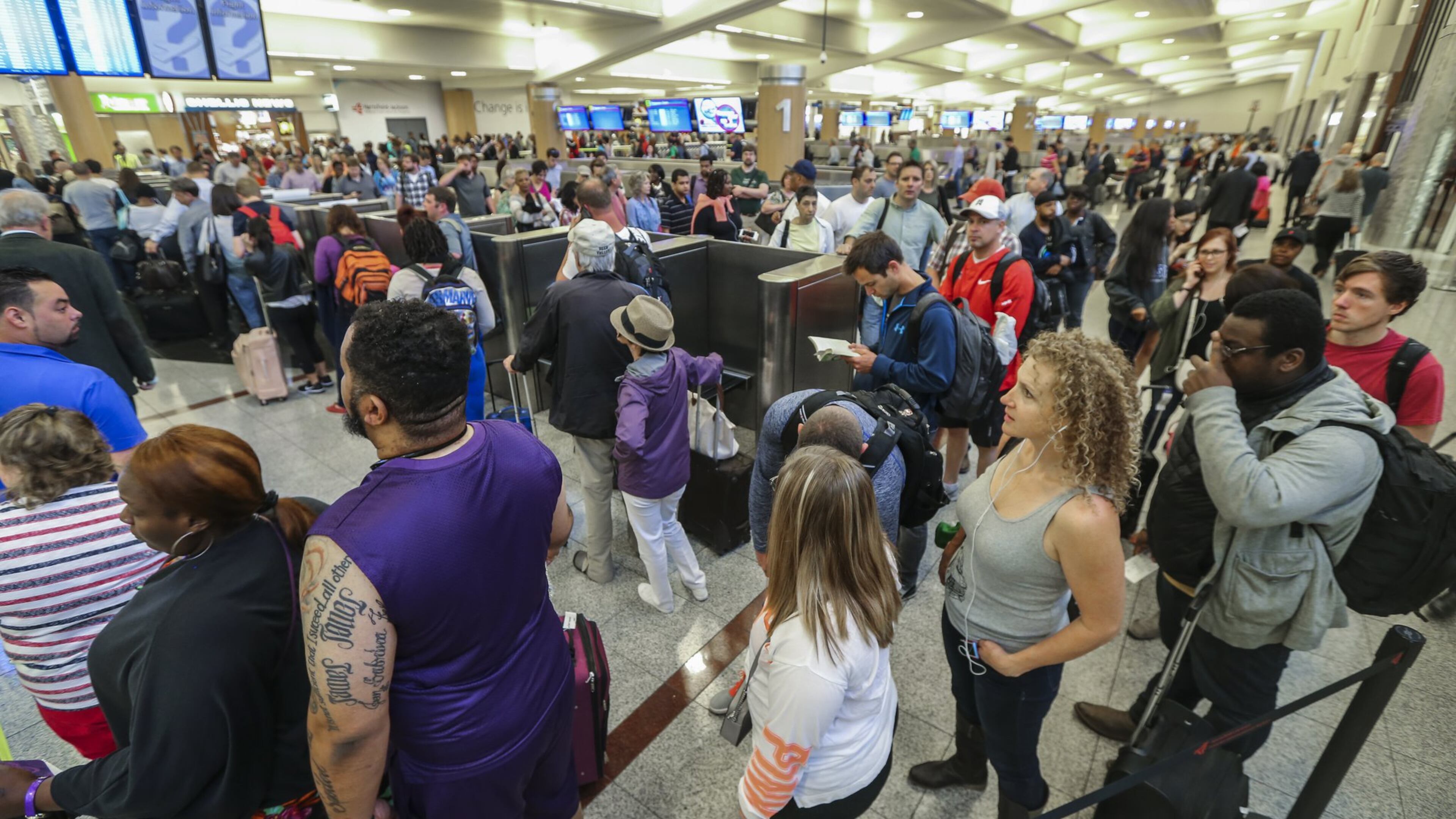 Long lines for airport security screening stretched through the domestic terminal and snaked through baggage claim at Hartsfield-Jackson International on Monday, May, 9, 2016. The airport is now advising travelers to get to the terminal three hours before their flight. JOHN SPINK / JSPINK@AJC.COM