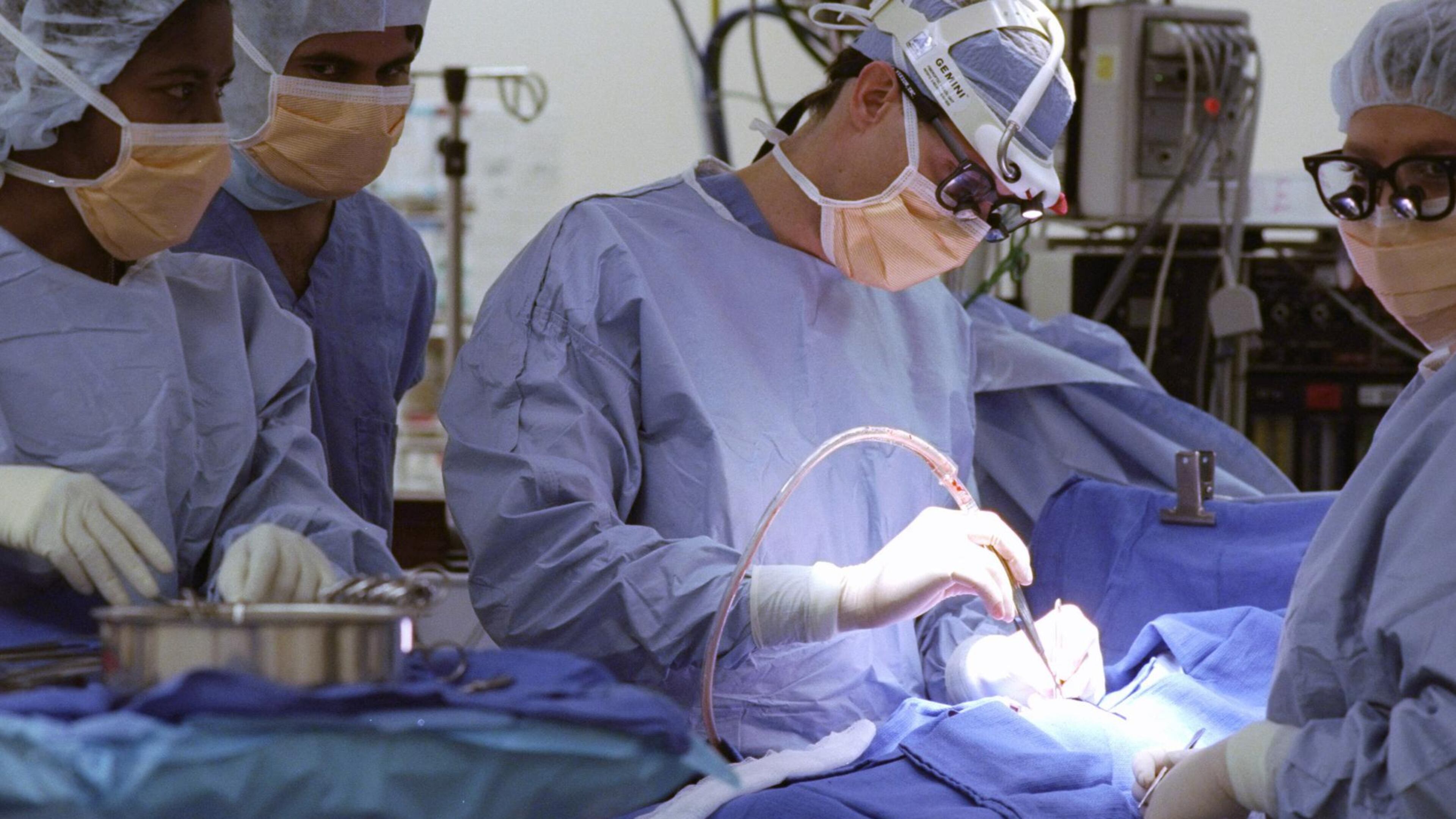 A doctor is performing open-heart surgery on a pateint. A new study on heart stents finds they don’t ease chest pain in most patients.