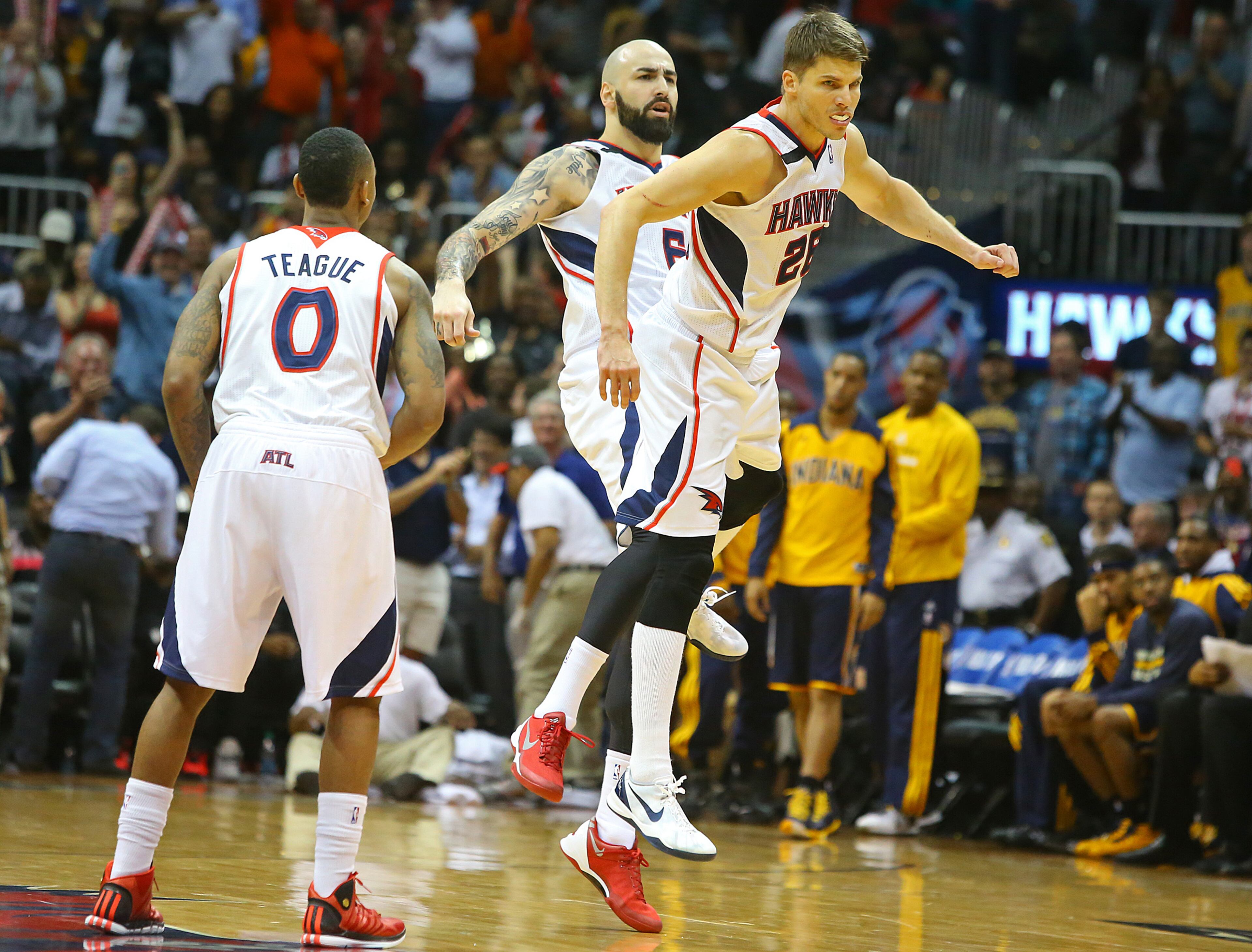Hawks Jeff Teague, Pero Antic, and Kyle Korver celebrate after Korver hits a three pointer in the final minutes beating the Pacers 98-85 for a 2 games to 1 lead during the second half of their NBA playoff game on Thursday, April 24, 2014, in Atlanta. CURTIS COMPTON / CCOMPTON@AJC.COM