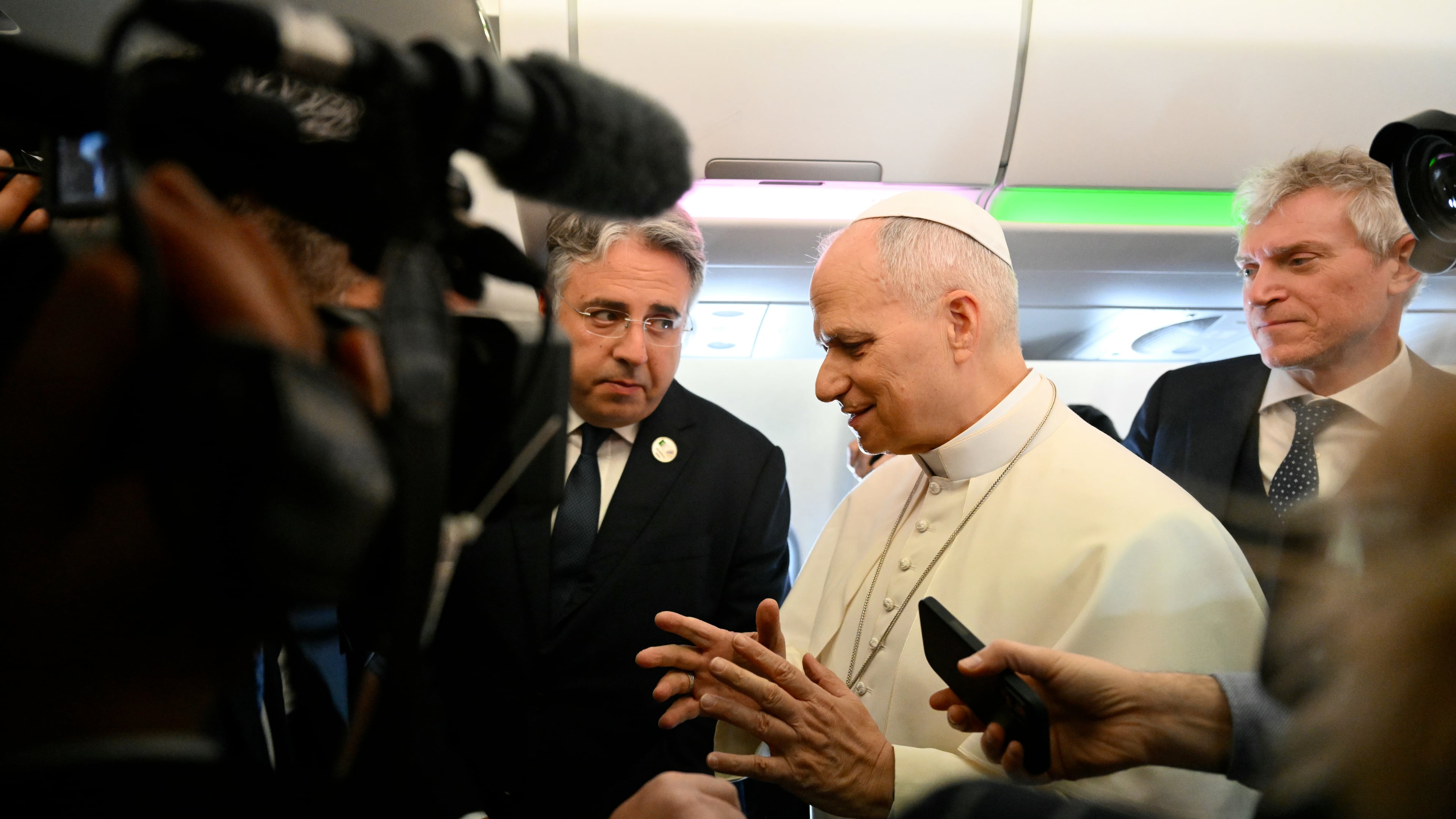 Pope Leo XIV speaks to journalists aboard his flight bound for Algiers’ Houari Boumédiène International Airport on Monday, April 13, 2026, at the start of an 11-day apostolic journey to Africa. (Alberto Pizzoli/Pool Photo via AP)