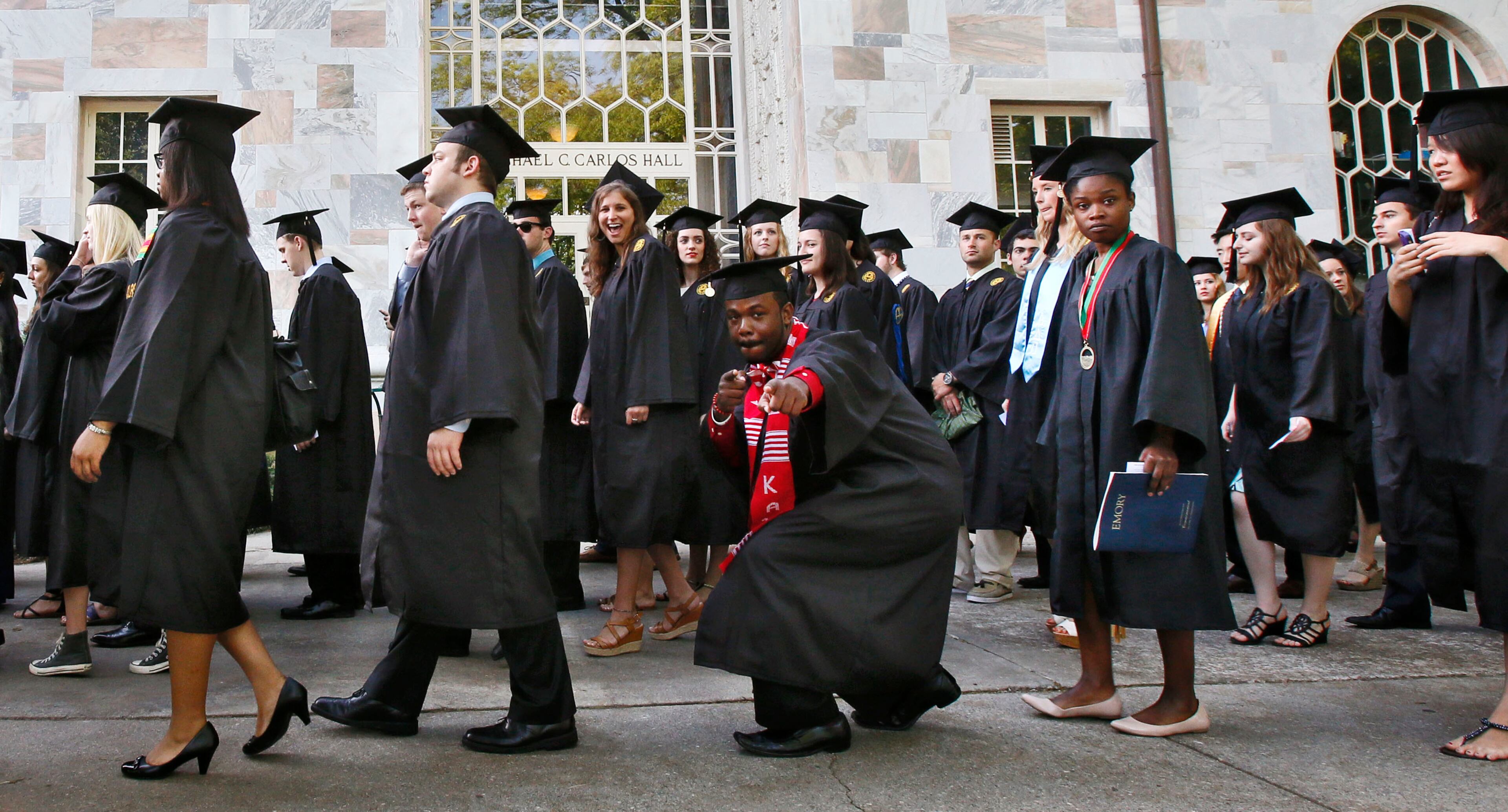 During the Processional, graduates display a variety of emotions and actions. U.S. Rep. and Civil Rights leader John Lewis was the keynote speaker at Emory University's 2014 spring commencement, Emory's 169th. 15,000 people were expected to attend. BOB ANDRES / BANDRES@AJC.COM