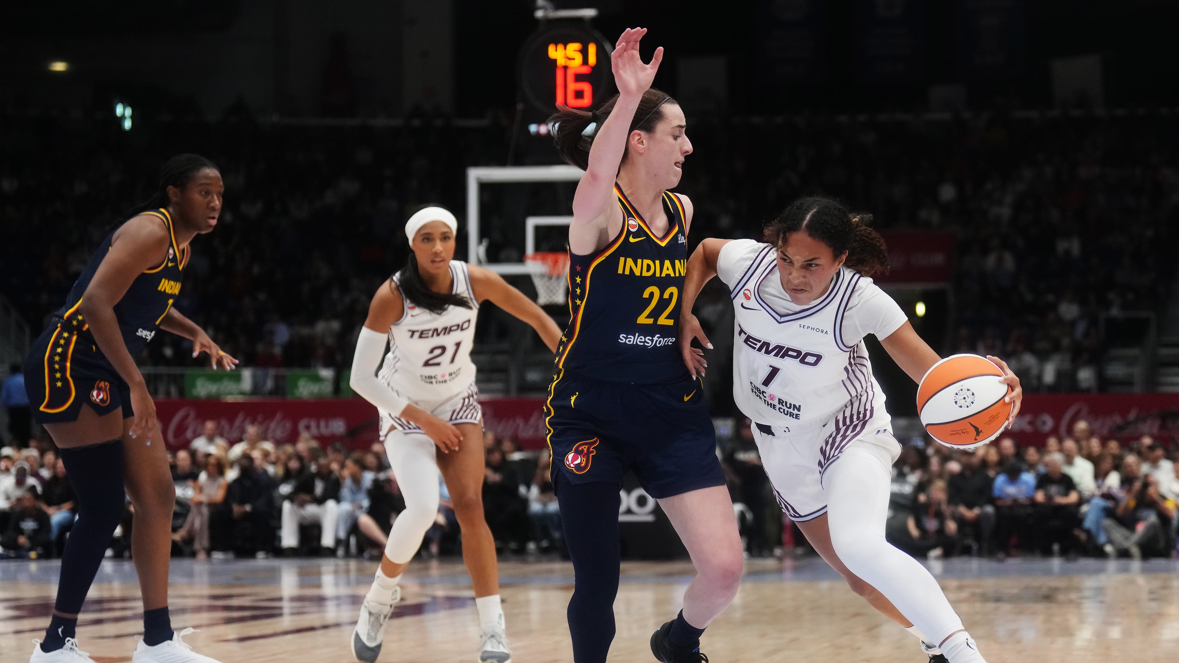 Toronto Tempo's Teonni Key, right, drives as Indiana Fever's Caitlin Clark (22) defends during the first half of a WNBA basketball game in Toronto, Friday, Sept. 18, 2026. (Nathan Denette/The Canadian Press via AP)