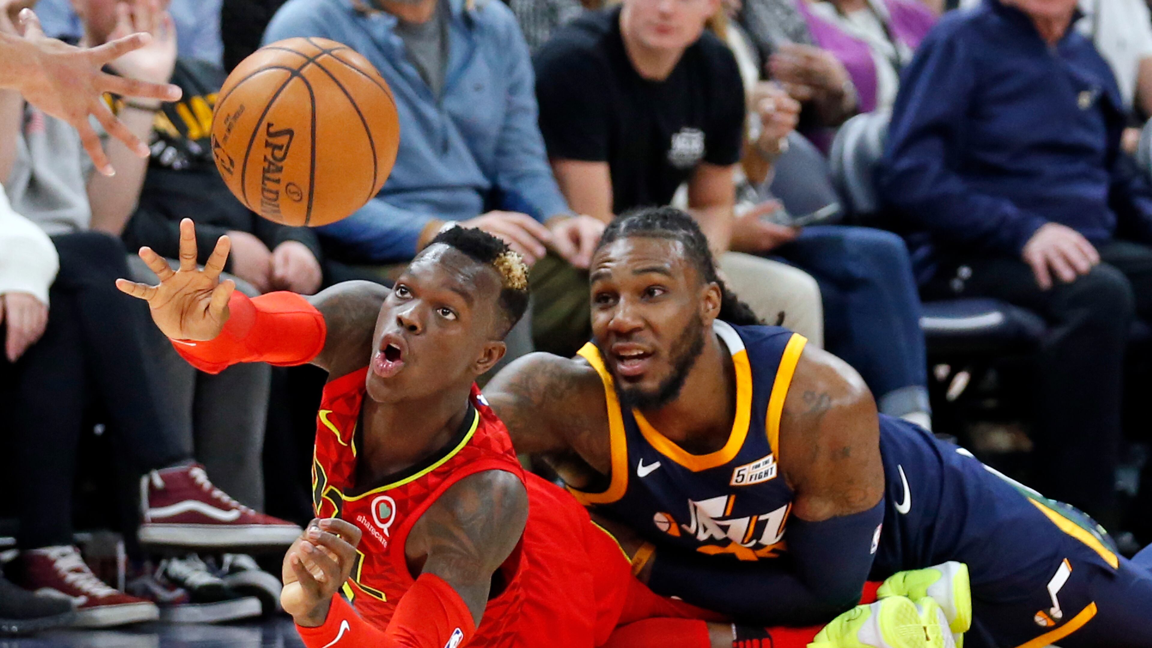 Hawks guard Dennis Schroder, left, passes the ball as Utah Jazz forward Jae Crowder, right, defends in the second half during an NBA basketball game Tuesday, March 20, 2018, in Salt Lake City. (AP Photo/Rick Bowmer)