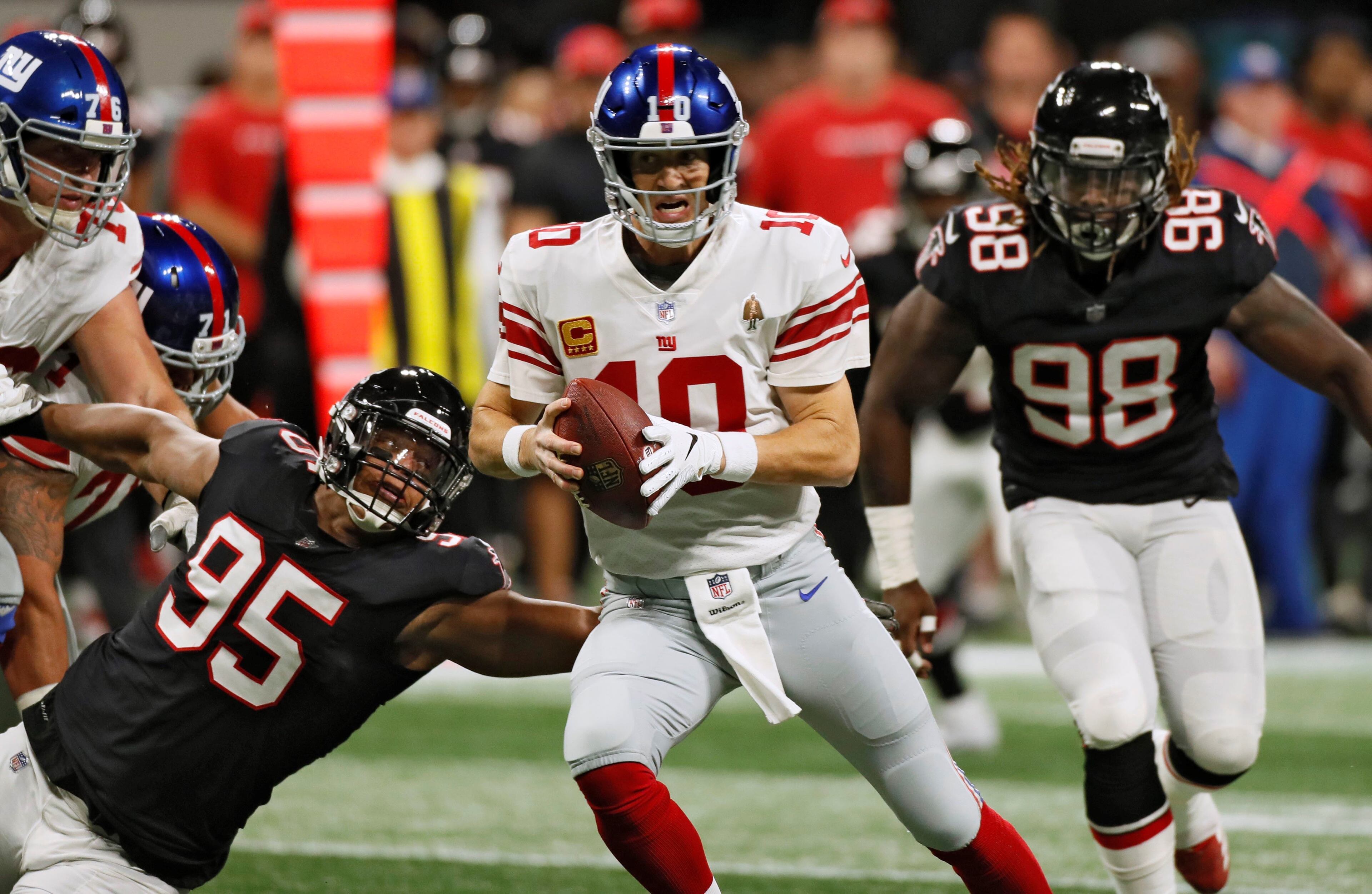 10/22/18 - Atlanta - Atlanta Falcons defensive end Jack Crawford (95) and Atlanta Falcons defensive end Takkarist McKinley (98) on one of Atlanta's sacks of New York Giants quarterback Eli Manning (10) in the first half. The Atlanta Falcons played the New York Giants in an NFL football game Monday, October 22, 2018, at Mercedes-Benz Stadium in Atlanta, GA. BOB ANDRES / BANDRES@AJC.COM