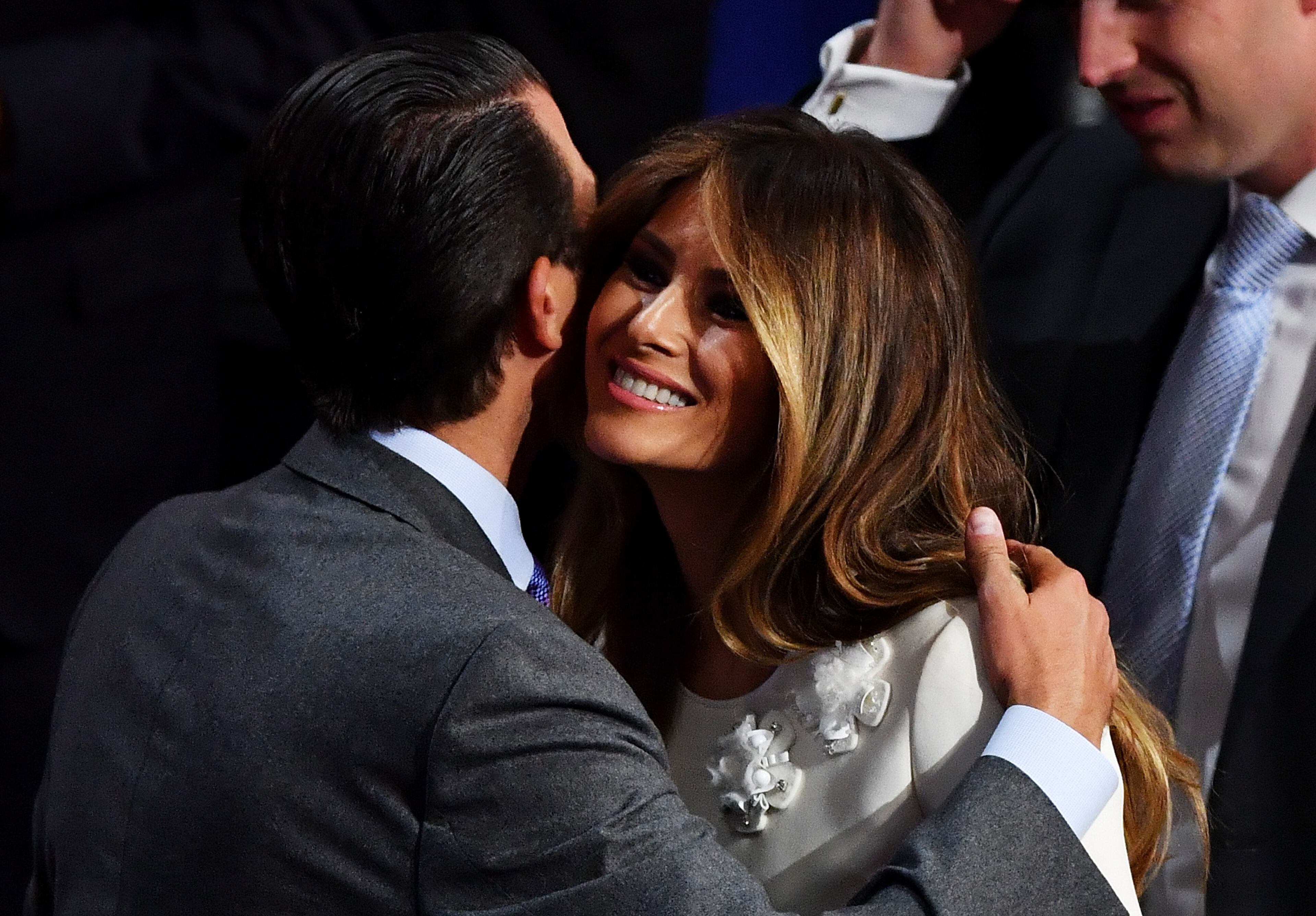 Donald Trump Jr. and Melania Trump embrance during the evening session on the fourth day of the Republican National Convention on July 21, 2016 at the Quicken Loans Arena in Cleveland, Ohio. (Photo by Jeff J Mitchell/Getty Images)