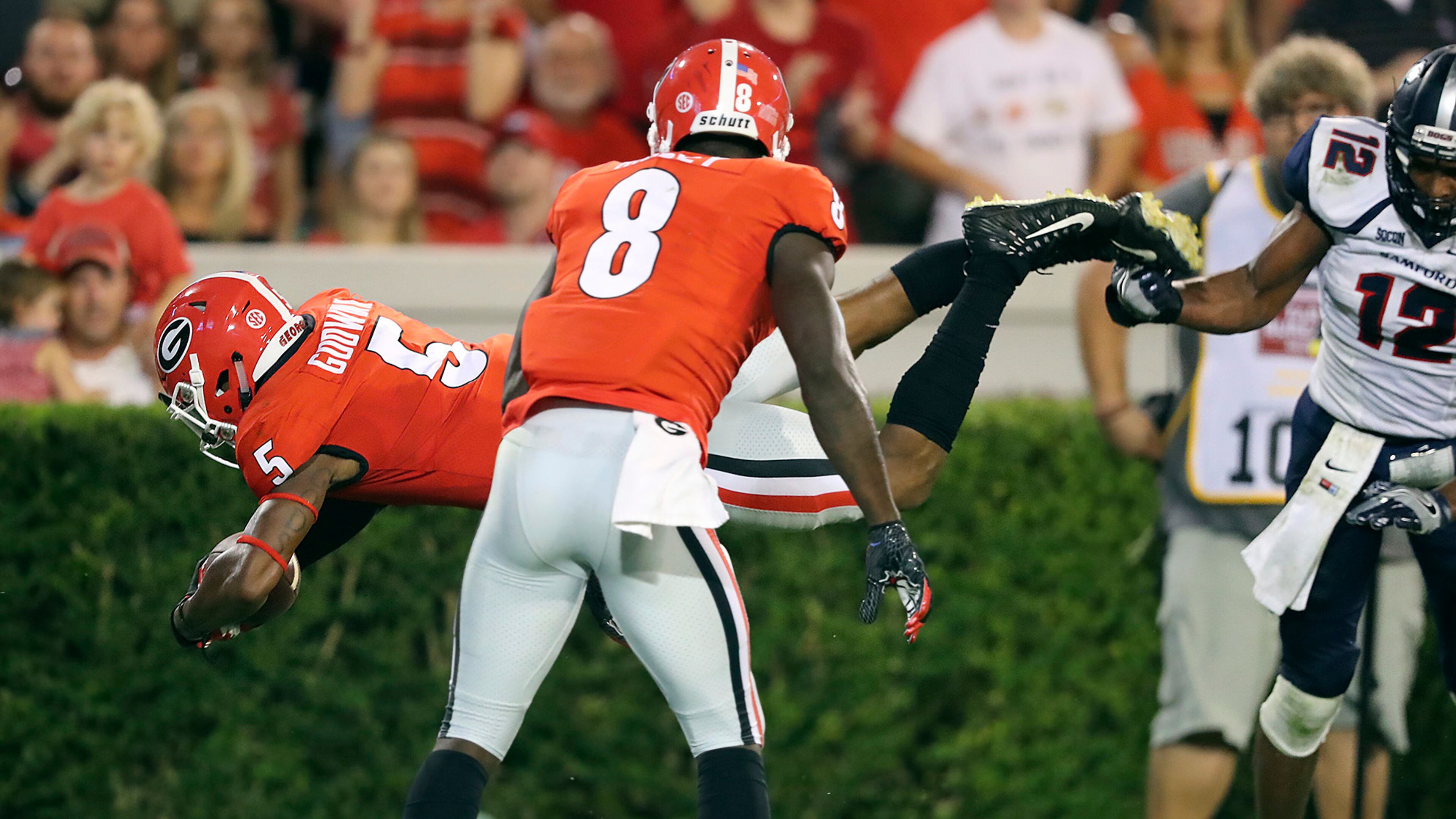 Georgia wide receiver Terry Godwin, left, leaps into the end zone against Samford for a touchdown during the second quarter of an NCAA college football game Saturday, Sept. 16, 2017, in Athens, Ga. (Curtis Compton/Atlanta Journal-Constitution via AP)