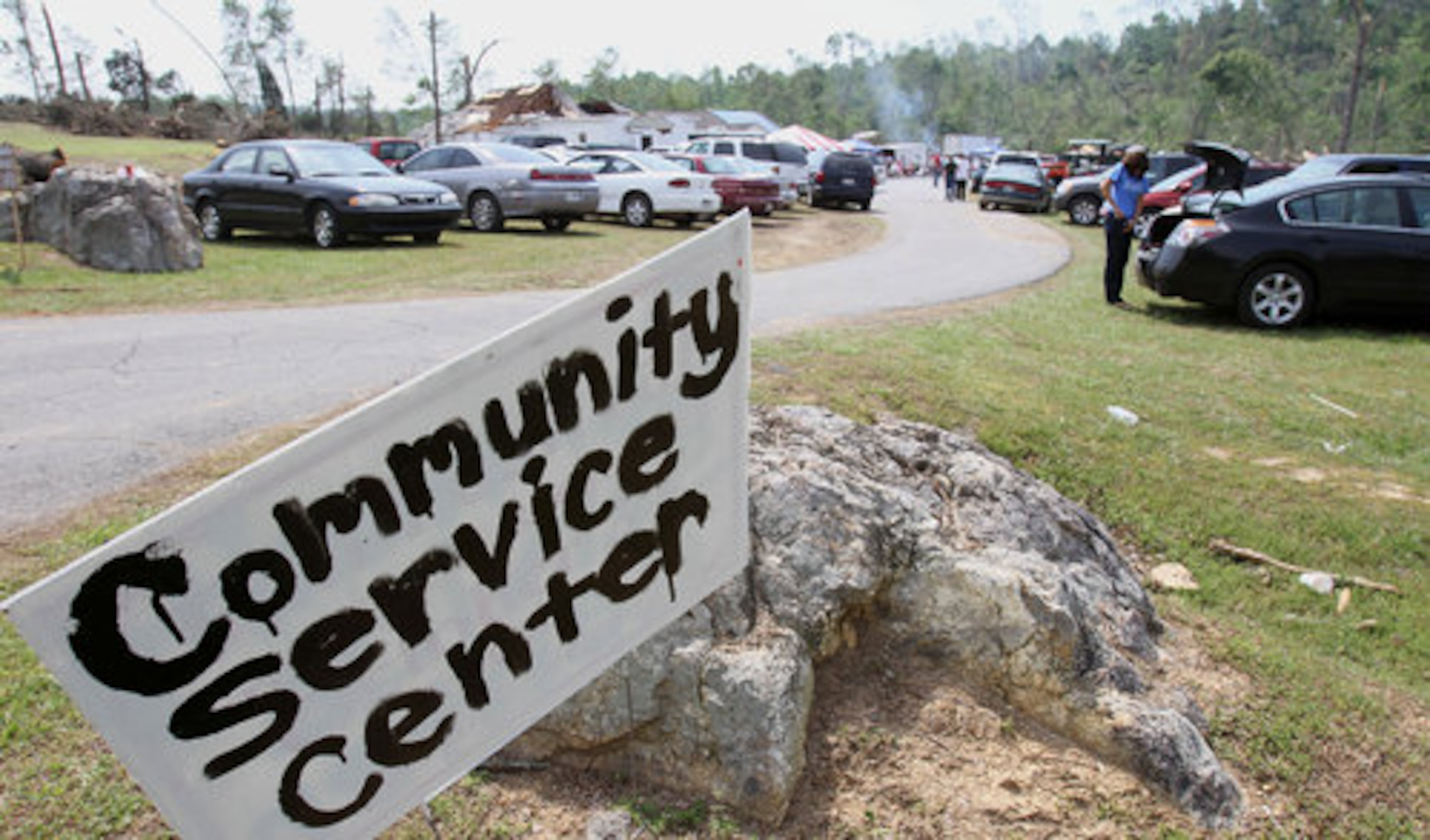 Battered by last week's twisters that roared through, members of the Crowe Springs Baptist Church held their service at their parking lot in Cartersville Sunday, May 1, 2011.
