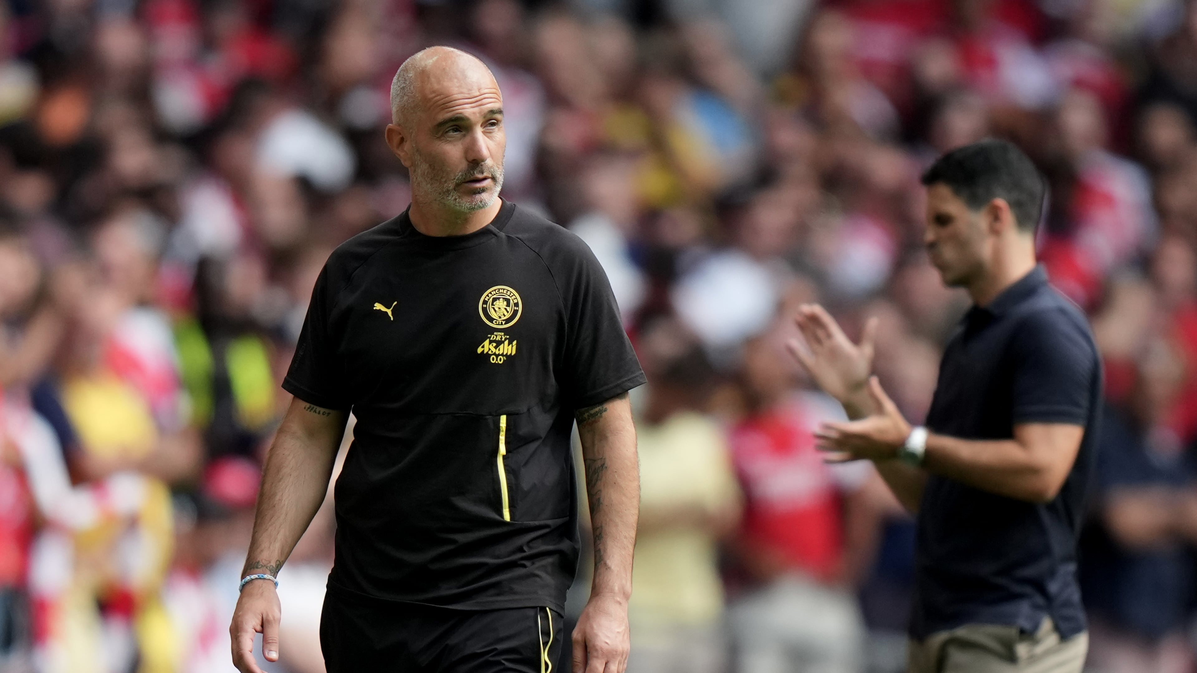 Manchester City's head coach Enzo Maresca, left, and Arsenal's manager Mikel Arteta react during the FA Community Shield final soccer match between Arsenal and Manchester City in Cardiff, Wales, Sunday, Aug.16, 2026. (AP Photo/Alastair Grant)