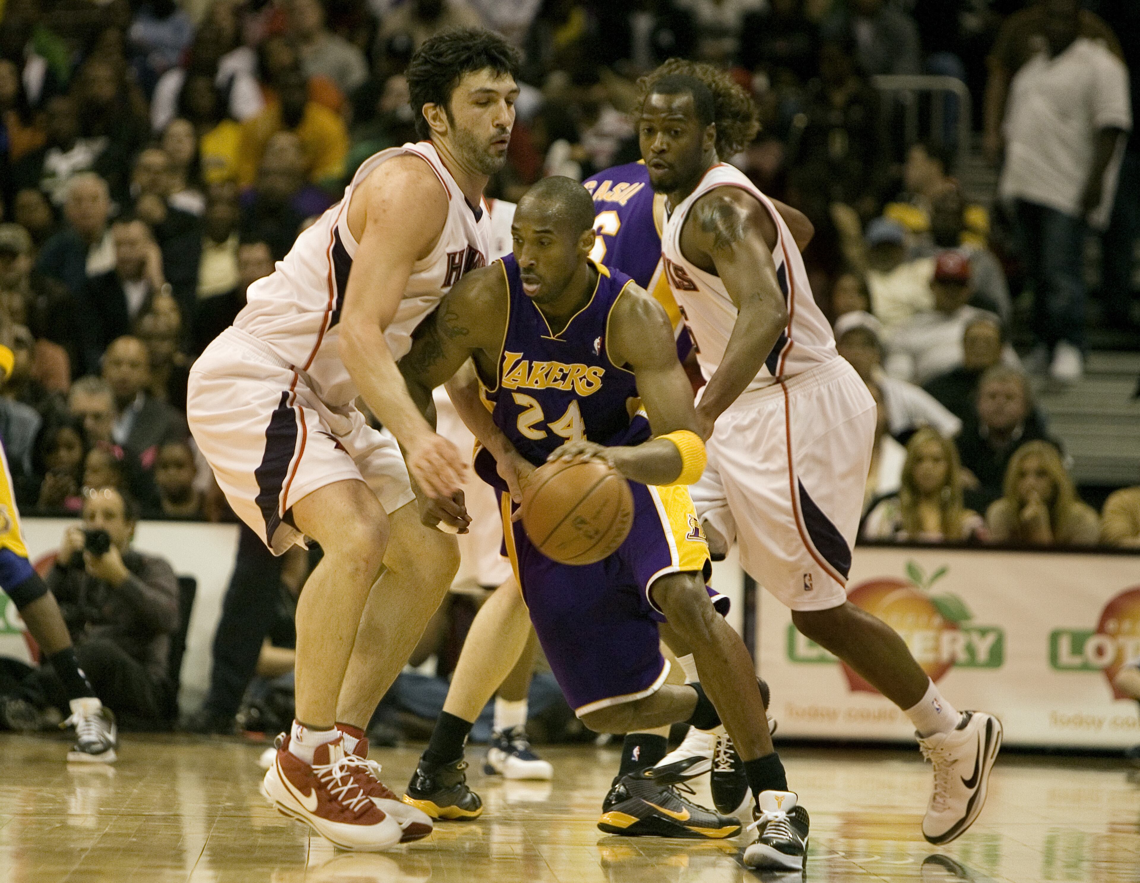 Zaza Pachulia (L) and Mario West (R) of the Hawks bottle up Kobe Bryant during the 2009 game at Philips Arena. (AJC file photo/Louie Favorite)