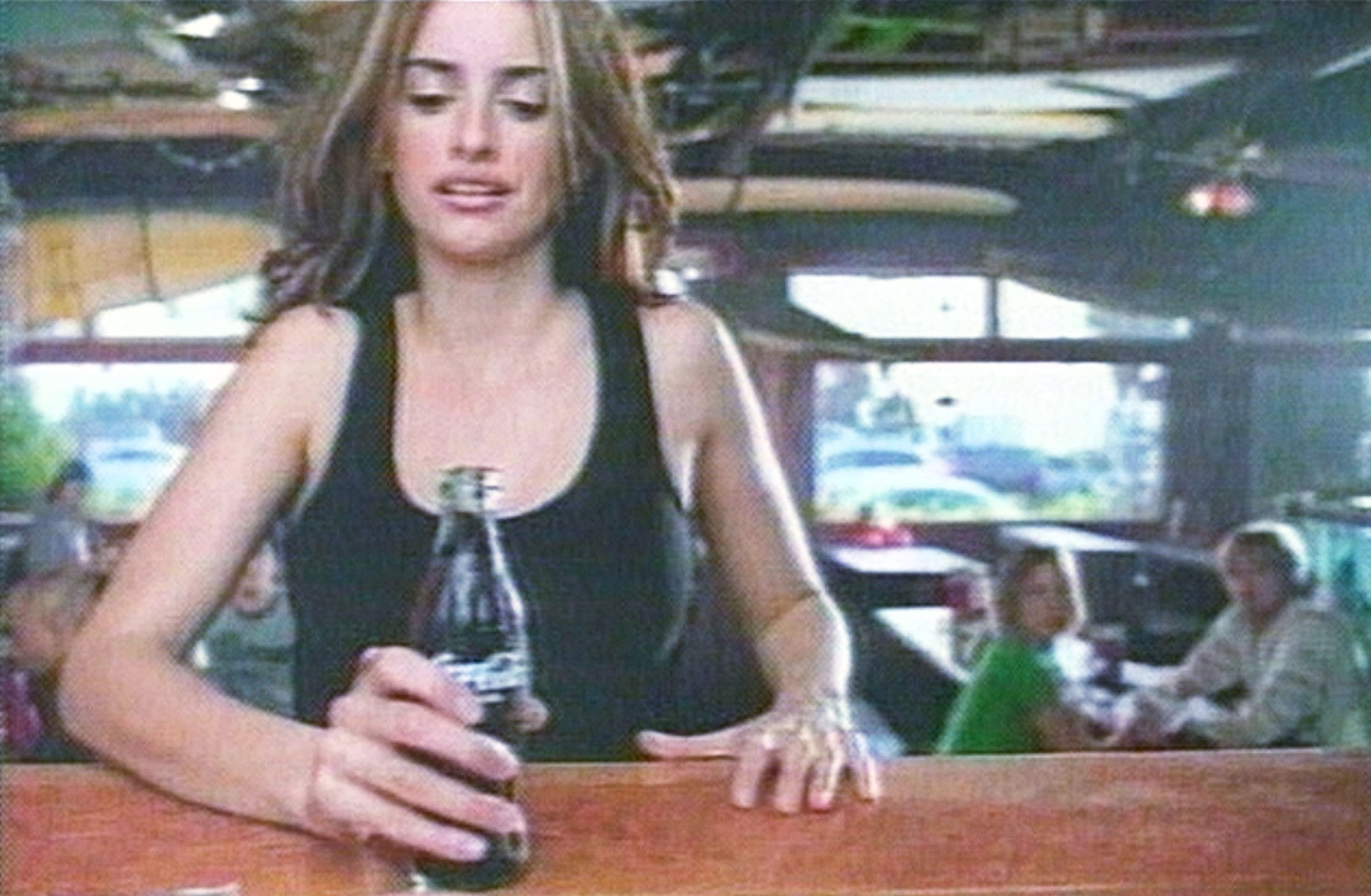 This undated handout image from video shows actor Penelope Cruz appearing in a new television advertising campaign for the Coca-Cola company. Coca-Cola is using actors and performers in "real-life" settings for their new ad campaign, in the hopes of attracting younger consumers. (Photo by Coca-Cola/Getty Images)