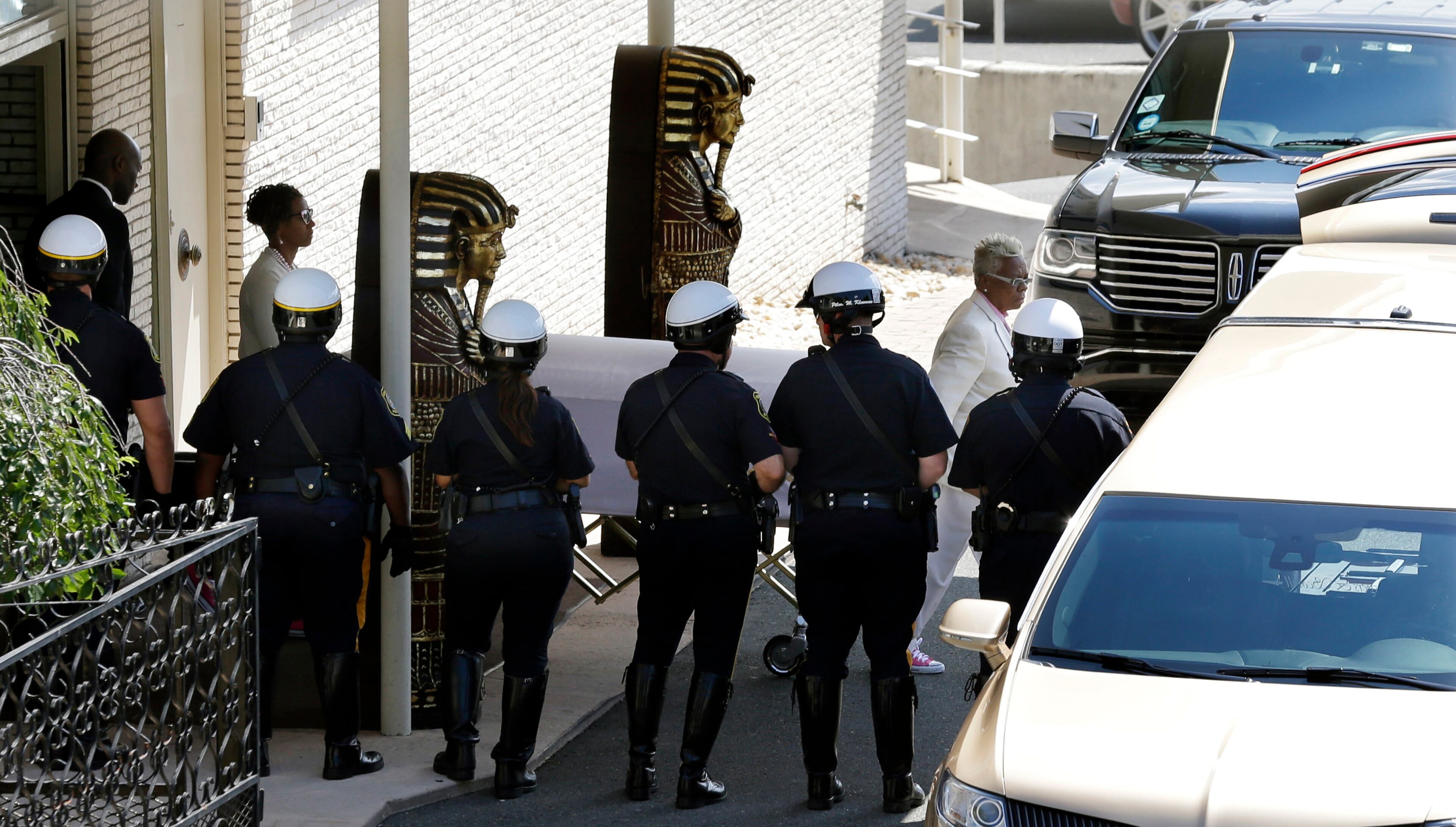 Carolyn Whigham leads Bobbi Kristina Brown's casket to a gold colored hearse after a service at Whigham funeral home in Newark, N.J., early Monday, Aug. 3, 2015. Bobbi Kristina, the only child of Whitney Houston and R&B singer Bobby Brown, died in hospice care July 26, about six months after she was found face-down and unresponsive in a bathtub in her suburban Atlanta townhome. (AP Photo/Mel Evans)