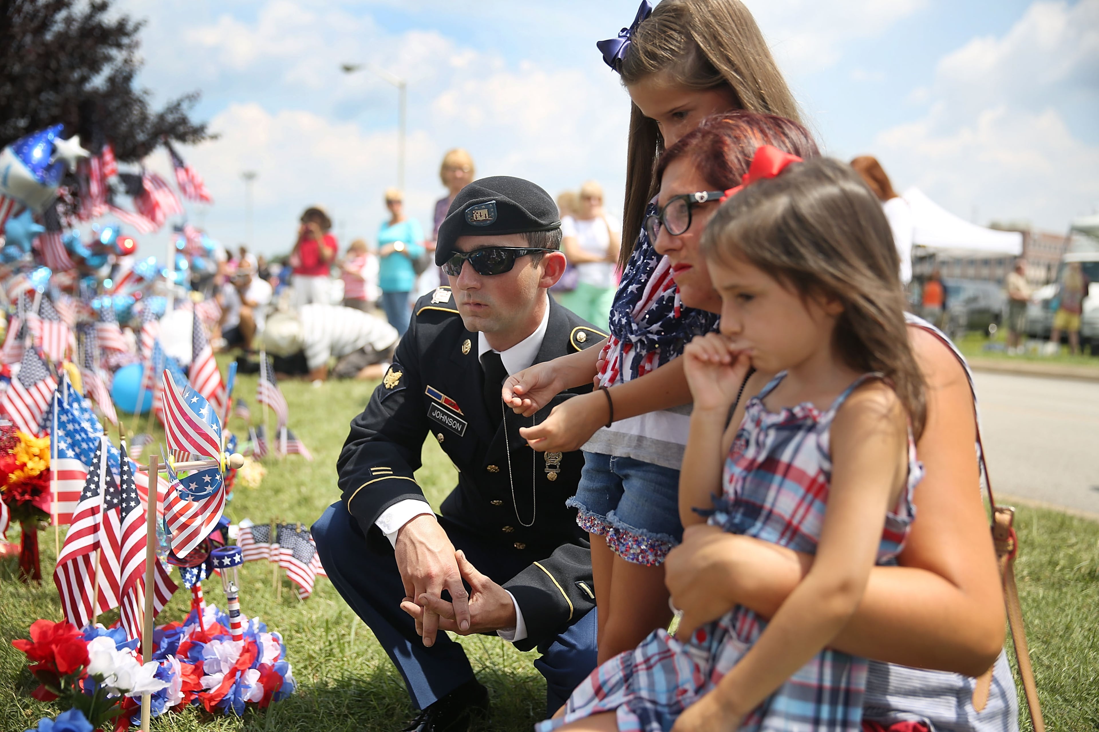 CHATTANOOGA, TN - JULY 18: Robert Johnson (l-r) Hannah Johnson,8, Jordan Johnson and Audrina Johnson,5, pay their respects at a memorial setup in front of the Armed Forces Career Center/National Guard Recruitment Office which had been shot up on July 18, 2015 in Chattanooga, Tennessee. According to reports, Mohammod Youssuf Abdulazeez, 24, opened fire on the military recruiting station at the strip mall on July 16th and then drove more than seven miles away to an operational support center operated by the U.S. Navy and killed four United States Marines and a Navy sailor. The gunman was likely killed in a exchange of gunfire with the police. (Photo by Joe Raedle/Getty Images)