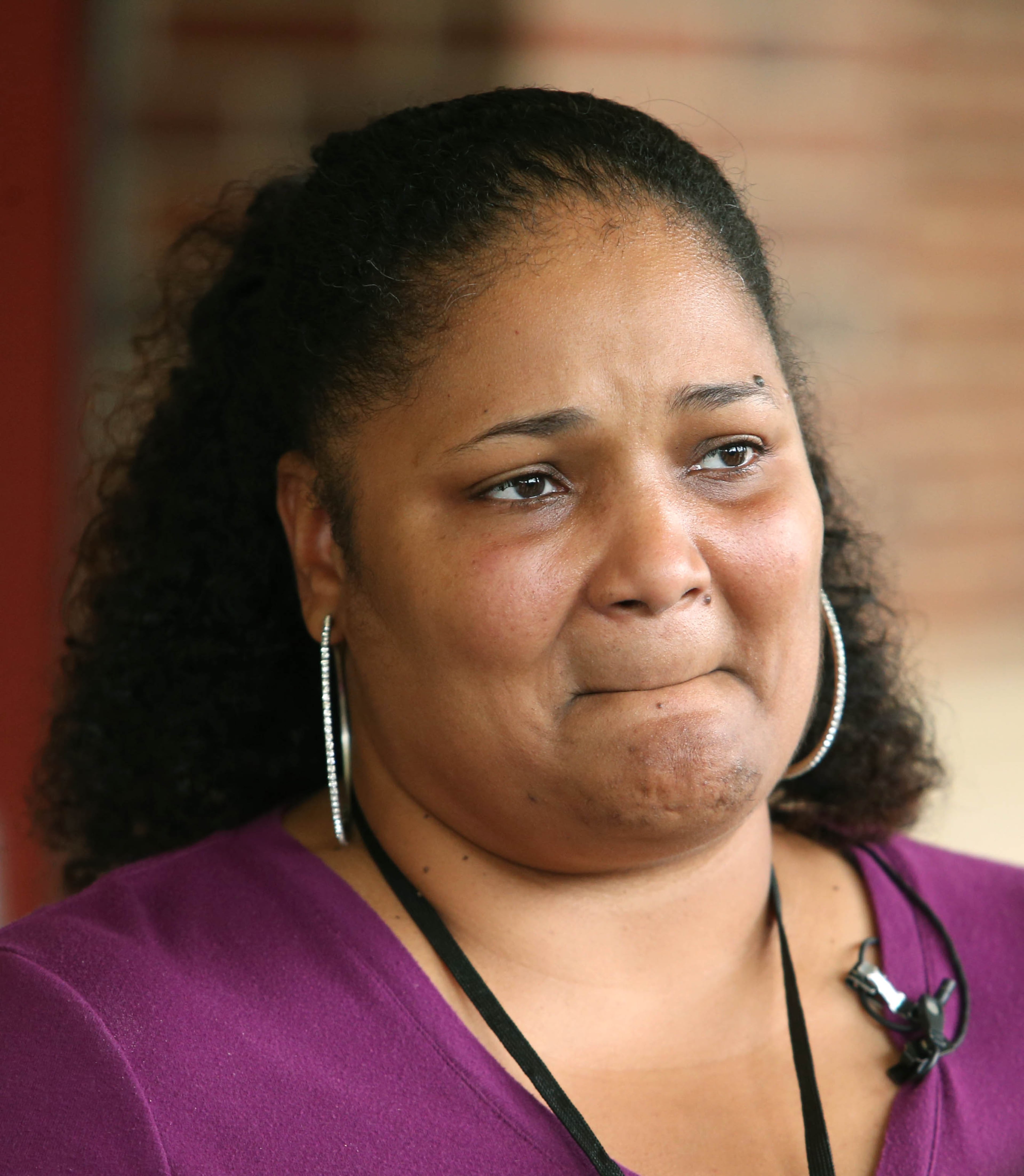 McNair Learning Academy fifth-grade teacher Pamela James shows her emotions as she speaks about her experience Tuesday during the standoff with members of the media at McNair High School on Wednesday morning in Atlanta.
