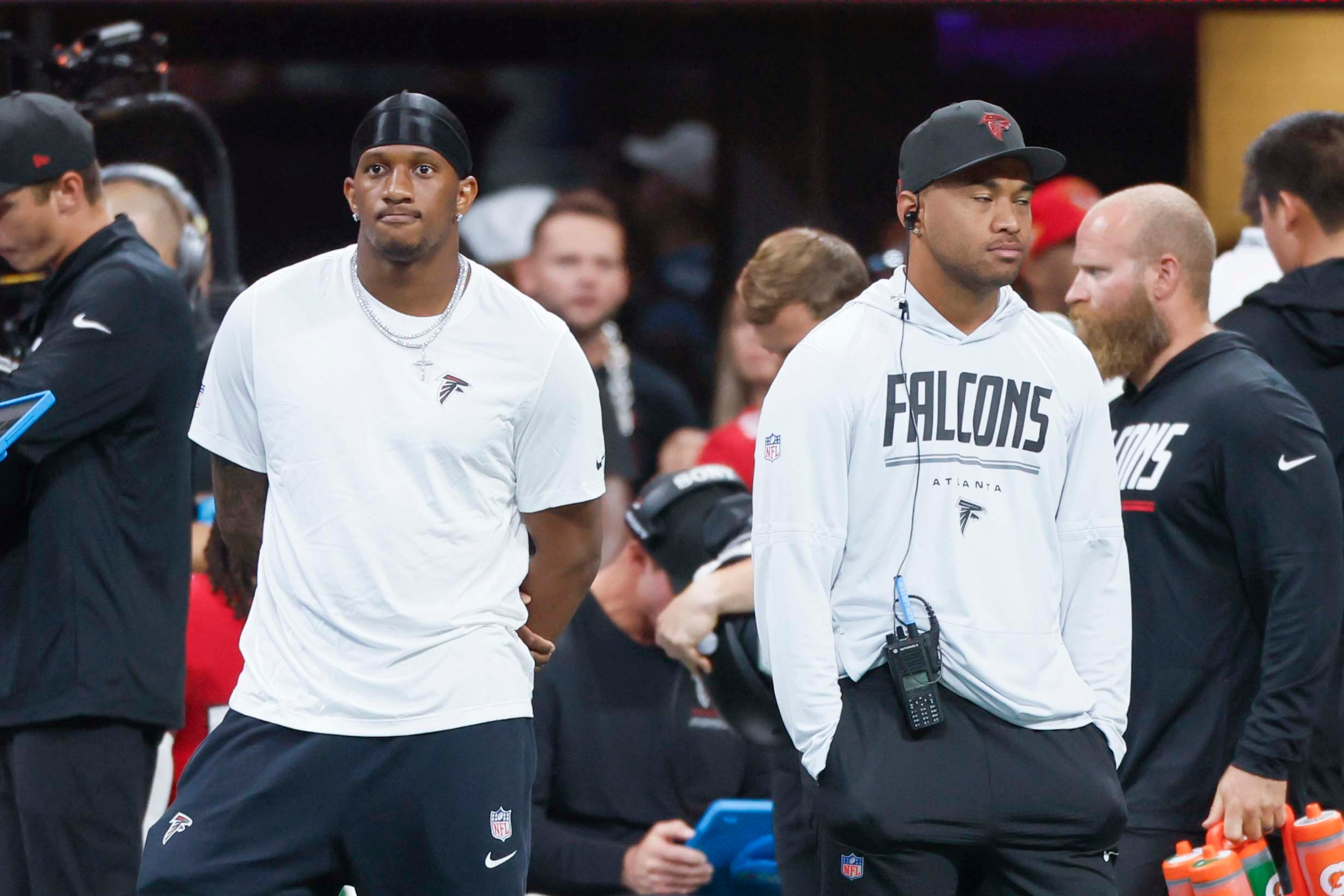 Falcons quarterbacks Michael Penix Jr. (left) and Tua Tagovailoa watch Sunday's blowout loss to the Panthers. (Miguel Martinez/AJC)