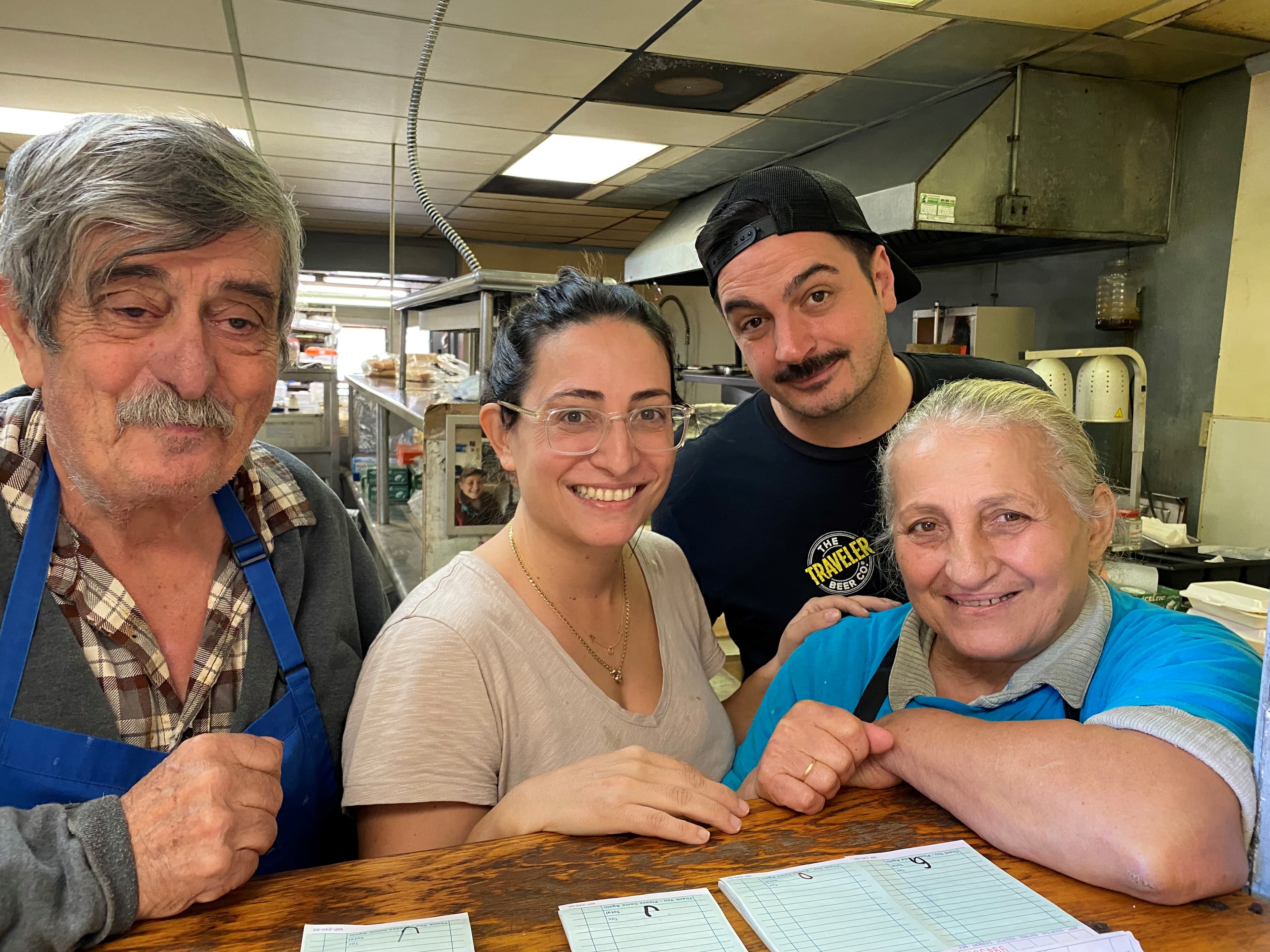 From left to right: Nick Poulos, Evie Poulos, Ben Poulos and Eleni (Helen) Poulos in the kitchen at Nick's Food To Go.
(Bob Townsend for the AJC)