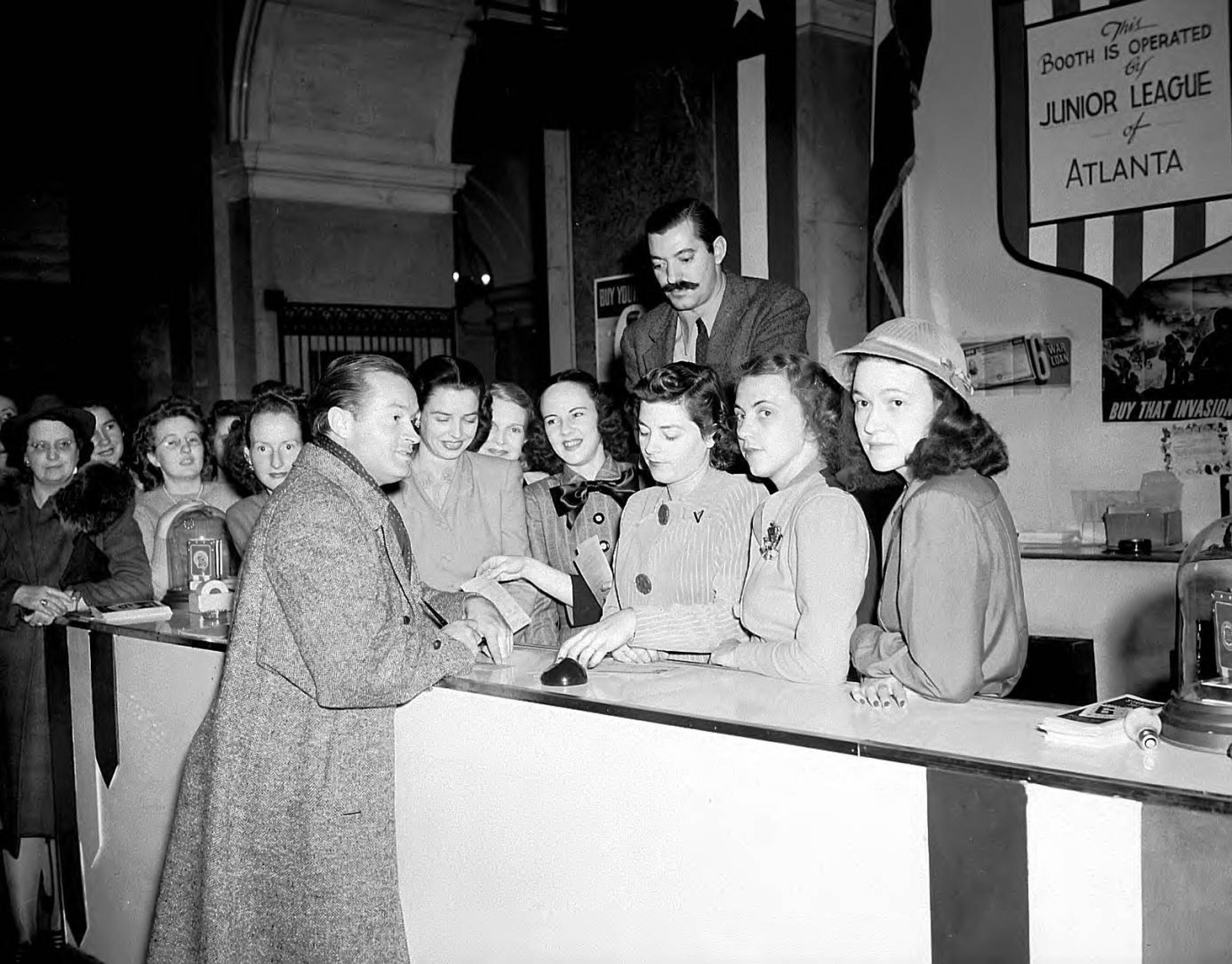 Bob Hope pays a visit to Atlanta to promote war bonds. He's seen here visiting with some members of the Junior League of Atlanta. LBPE2-011a, Lane Brothers Commercial Photographers Photographic Collection, 1920-1976. Photographic Collection, Special Collections and Archives, Georgia State University Library.
