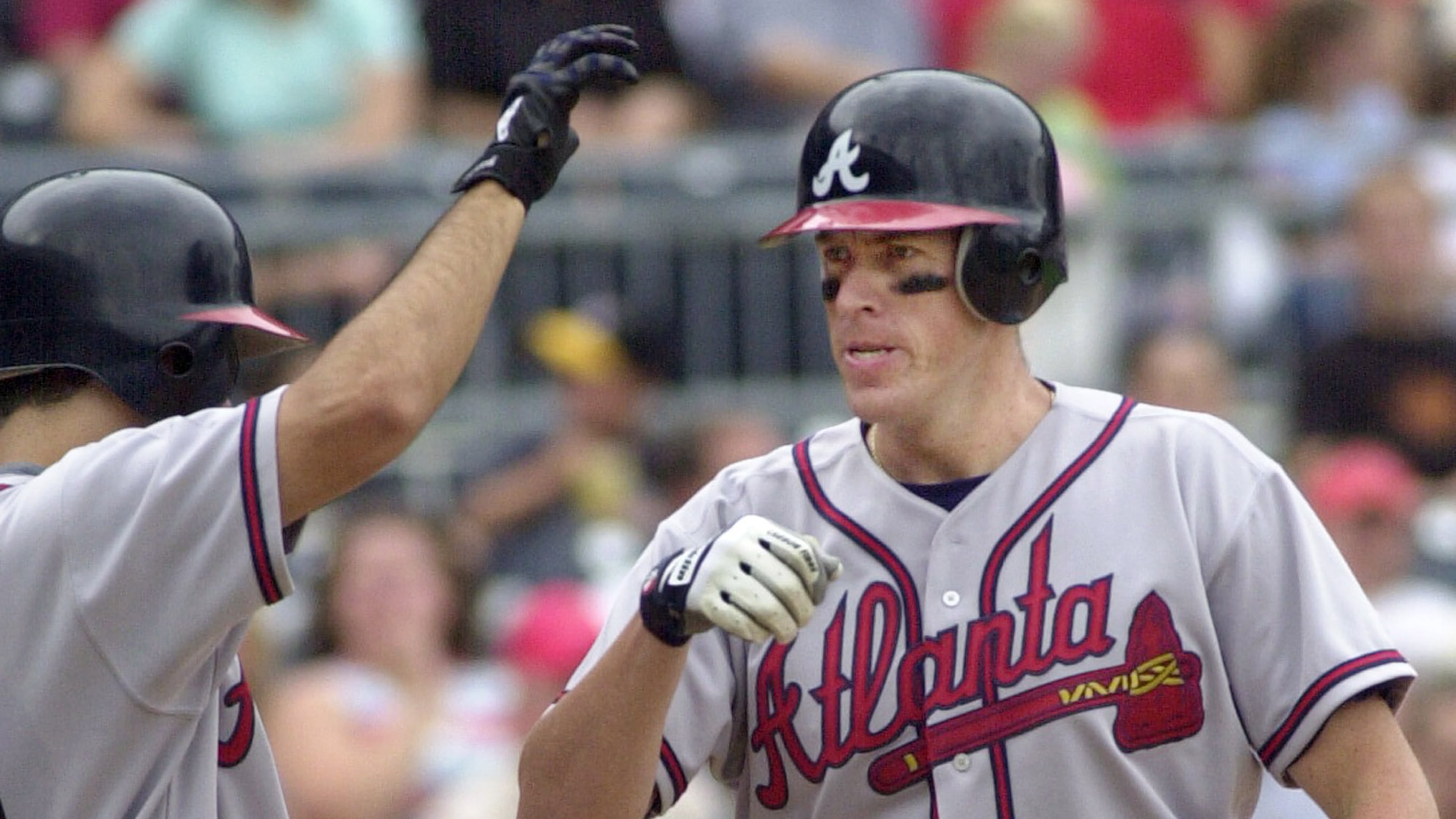 The Braves' Mike Hessman (right) is met at the plate by teammate Mark DeRosa after hitting two-run home run in the third inning against the Pittsburgh Pirates on Saturday, Aug. 30, 2003, in Pittsburgh. (AP file photo)