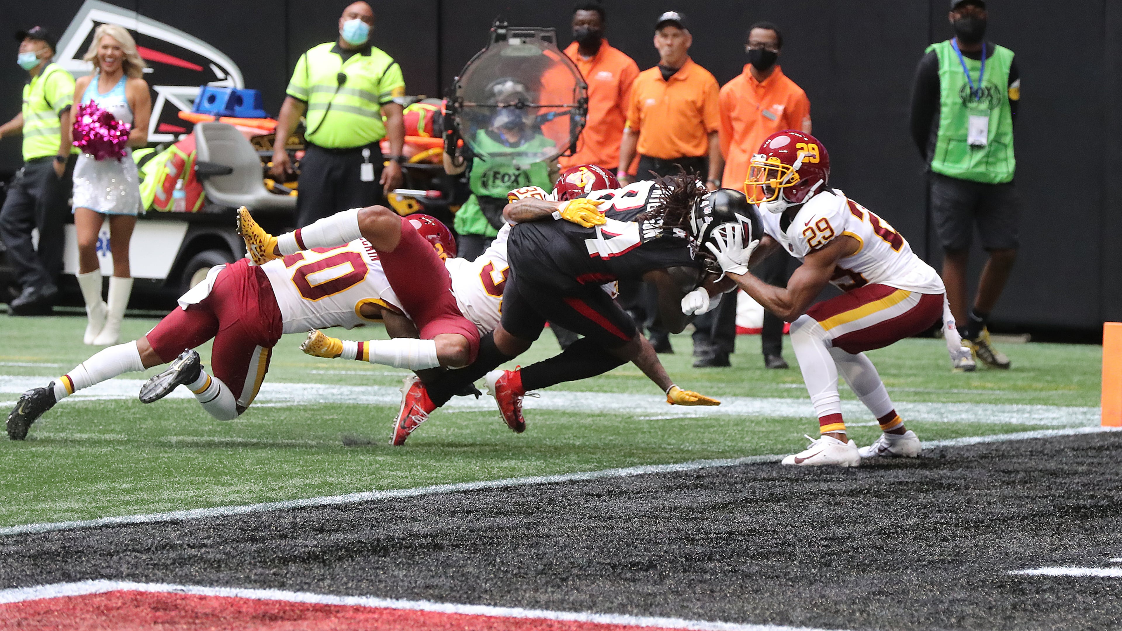 Falcons running back Cordarrelle Patterson bears down to reach the end zone against three defenders to take a 17-13 lead over the Washington Football Team during the final minute of the second quarter Sunday, Oct. 3, 2021, at Mercedes-Benz Stadium in Atlanta. (Curtis Compton / Curtis.Compton@ajc.com)