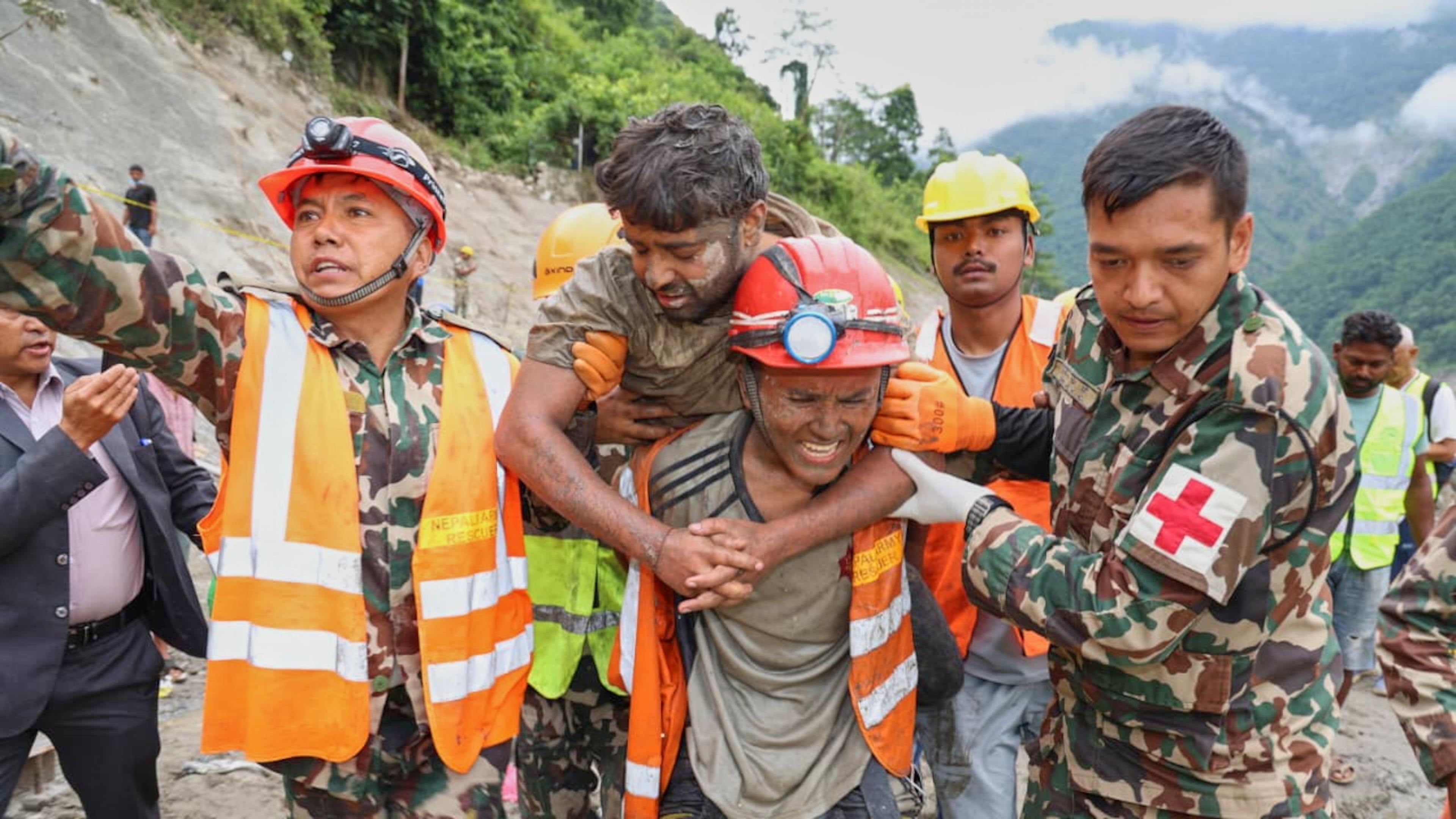 In this photo provided by the Nepal Army, soldiers rescue a worker alive from a tunnel during an ongoing operation at the Trishuli-3A hydropower project in Nepal's Rasuwa district, Friday, Sept. 4, 2026. (Nepal Army via AP)