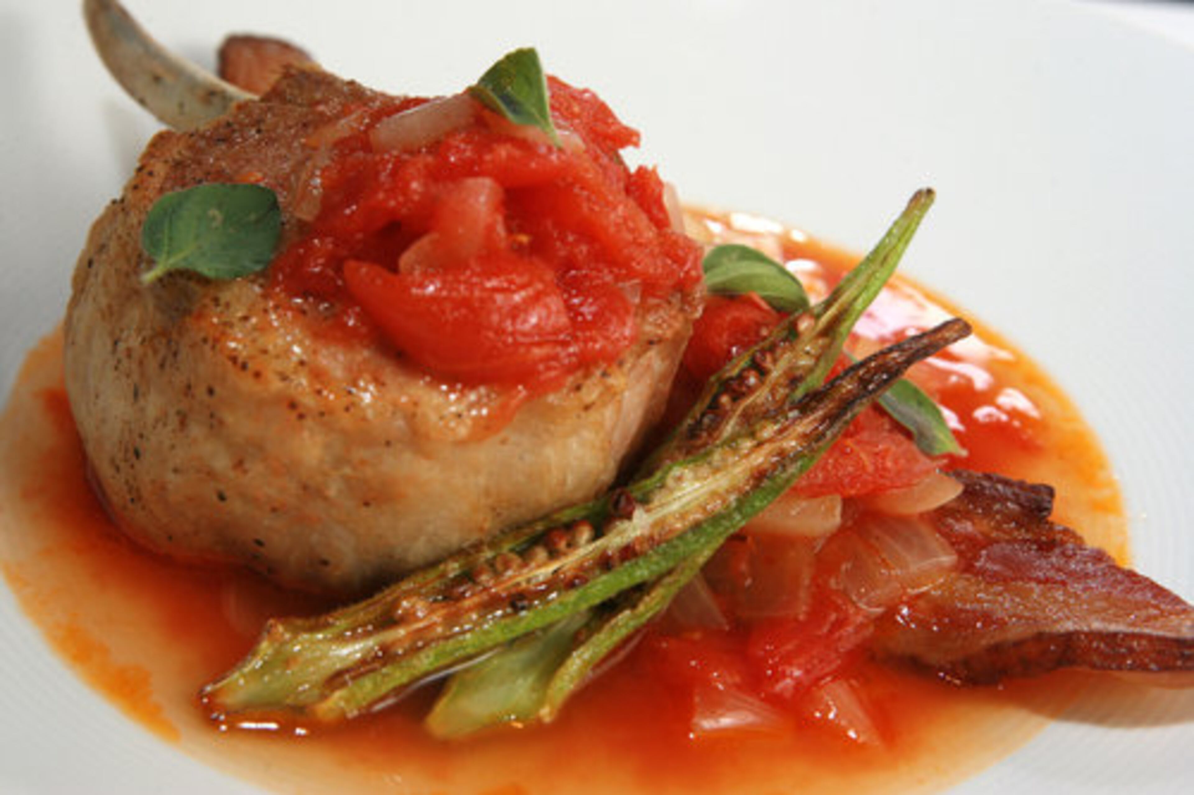 A broiled pork chop with tomato gravy is one way that Bacchanalia chef/co-owner Annie Quatrano interprets Southern cuisine.