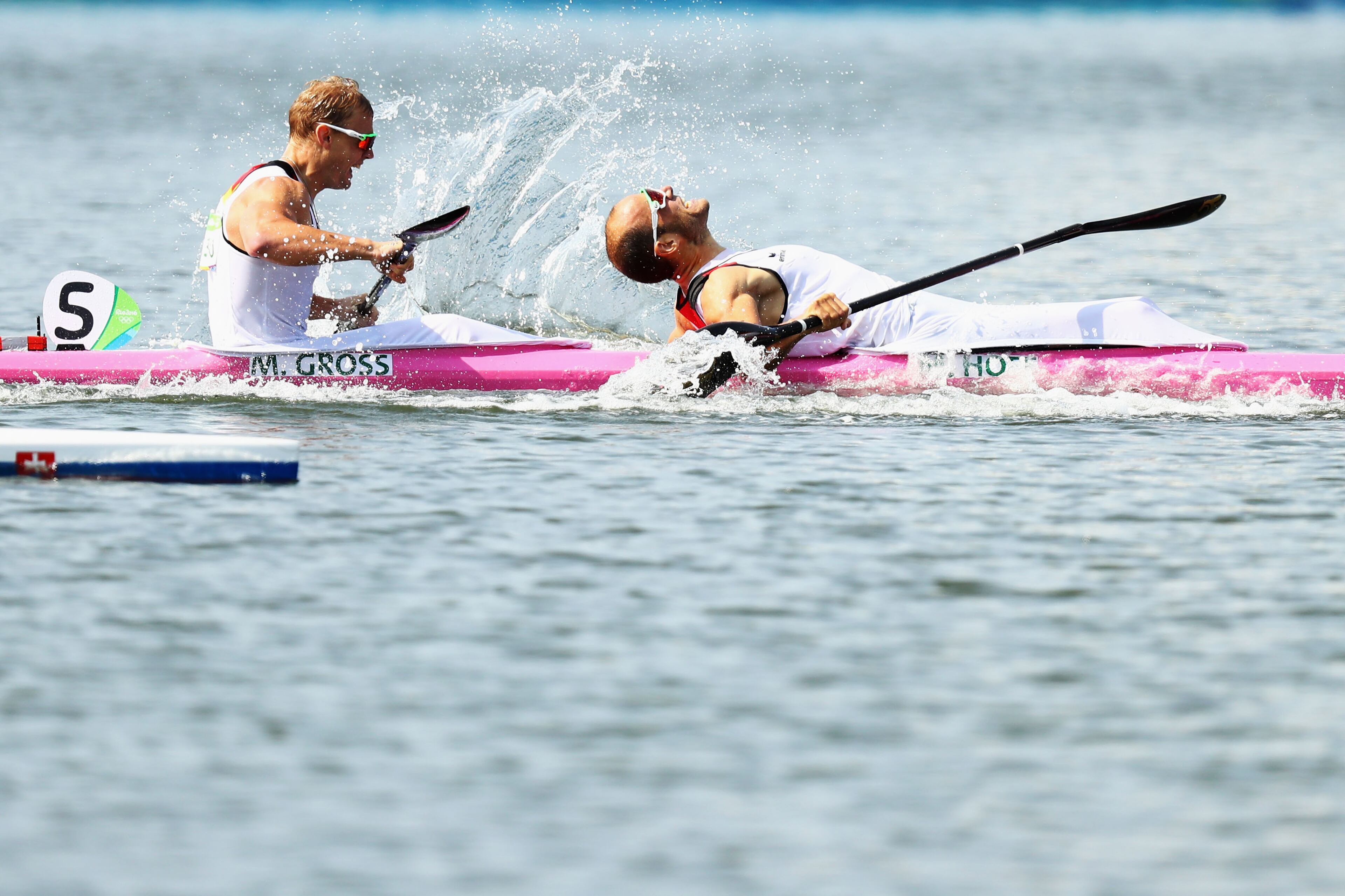 RIO DE JANEIRO, BRAZIL - AUGUST 20: Max Hoff of Germany and Marcus Gross of Germany celebrate winning with team mates Max Rendschmidt of Germany, Tom Liebscher of Germany in the Men's Kayak Four 1000m on Day 15 of the Rio 2016 Olympic Games at the Lagoa Stadium on August 20, 2016 in Rio de Janeiro, Brazil. (Photo by Ryan Pierse/Getty Images)