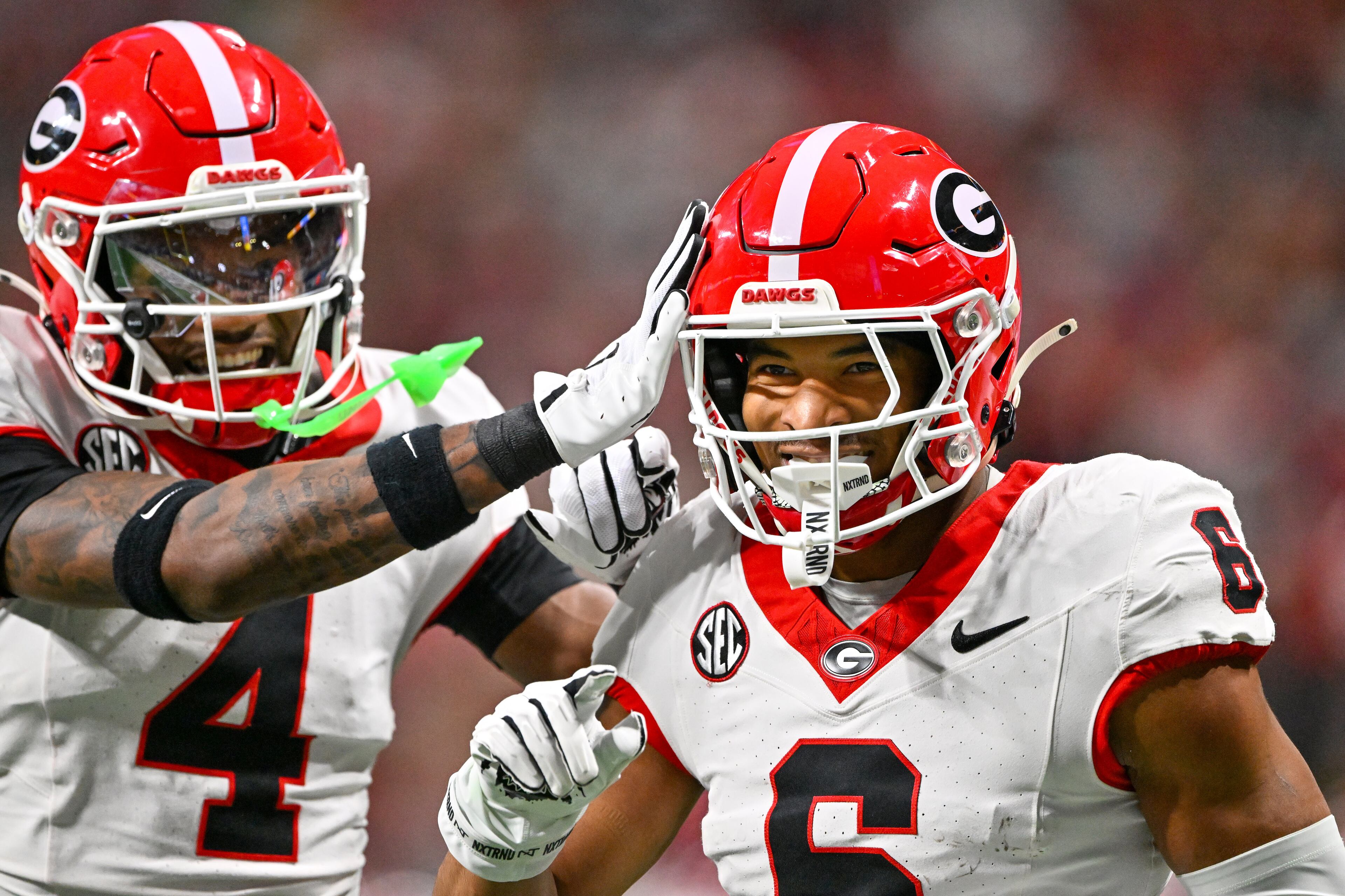 Georgia defensive back Daylen Everette (6) celebrates with KJ Bolden (4) after intercepting a pass from Alabama quarterback Ty Simpson during the first half of the SEC Championship game at Mercedes-Benz Stadium, Saturday, Dec. 6, 2025, in Atlanta. (Hyosub Shin / AJC)
