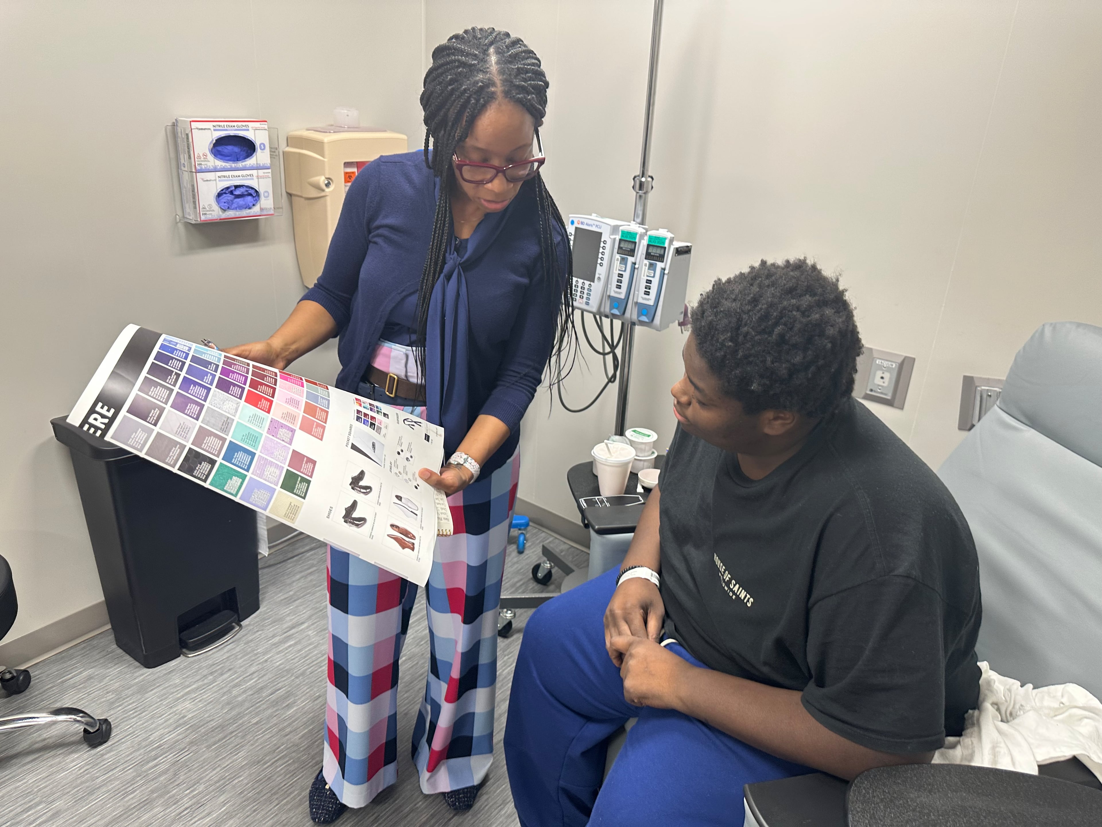 Malik King picks out his formal wear, donated by Men's Wearhouse in Lithonia. The 18-year-old senior at Newton High School is undergoing cancer treatments. Photo courtesy of Piedmont Newton Hospital